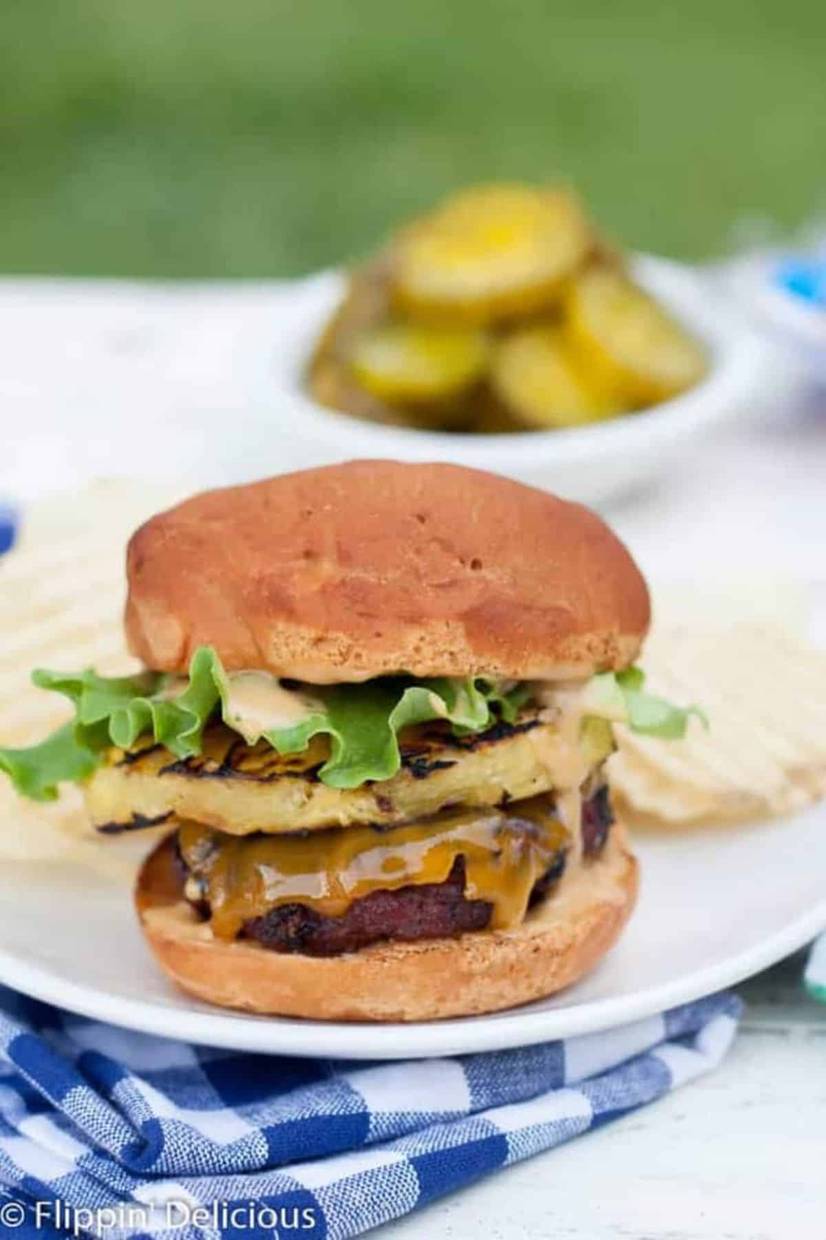 Flavorful Gluten-Free Teriyaki Grilled Pineapple Burger on a white plate.