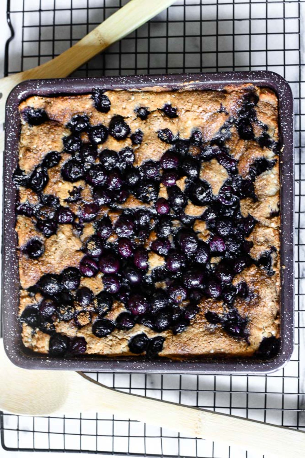 Delicious Paleo Blueberry Cobbler on a resting grid.