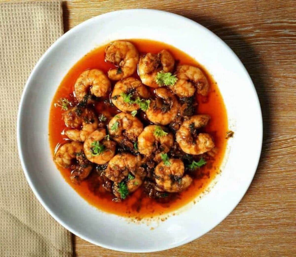 Deliicous  Gambas al Ajillo (Spanish-Style Garlic Shrimp) on a white plate.