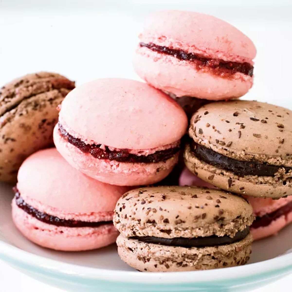 Delicious Raspberry Macarons on a white plate.