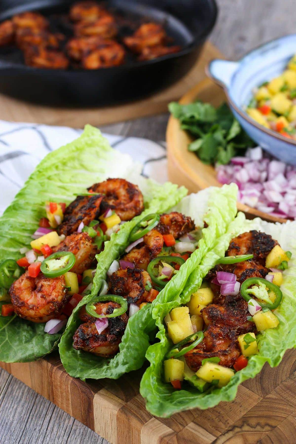 Crunchy Blackened Shrimp Tacos on a wooden tray.