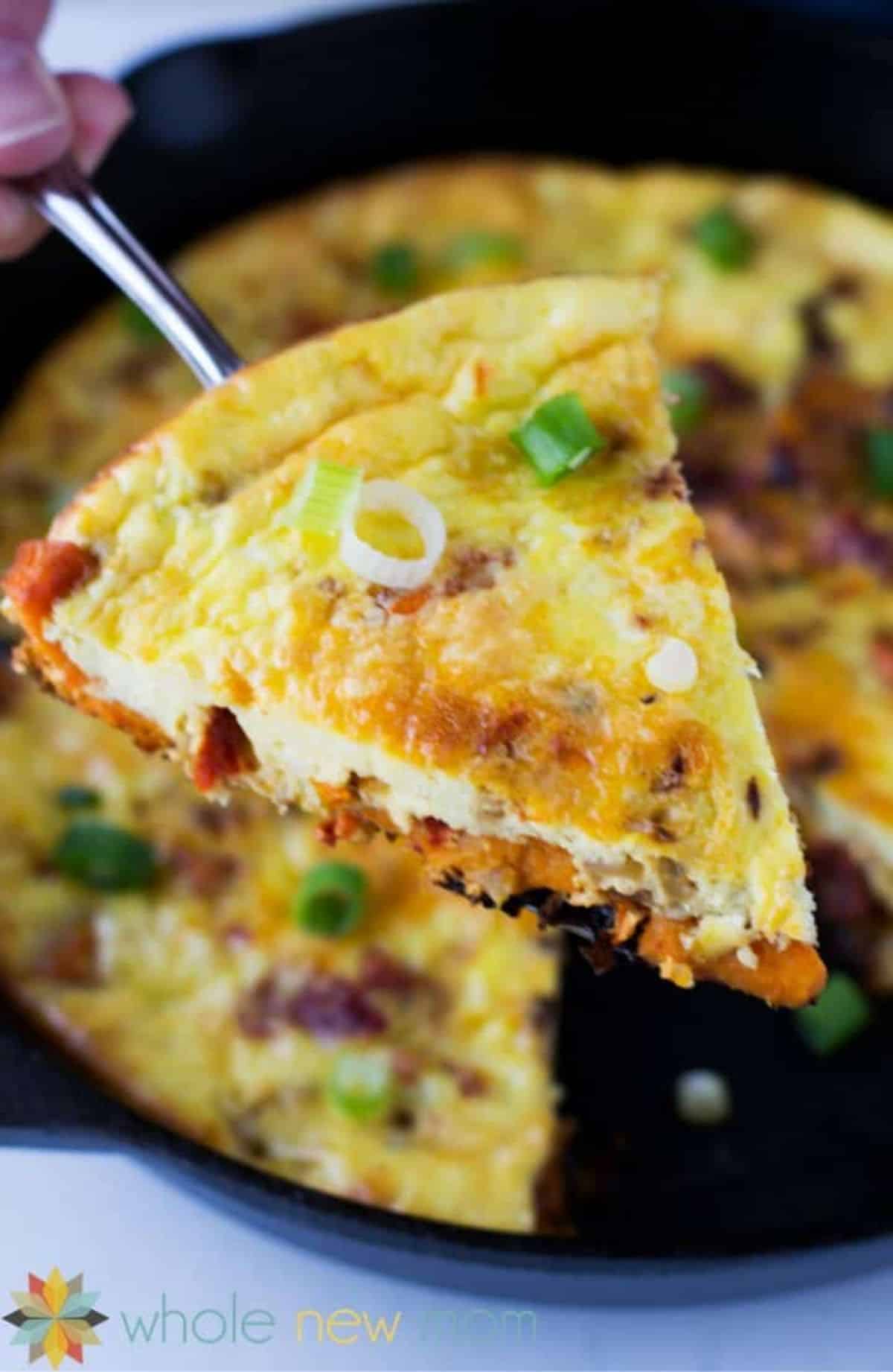 A piece of Delicious Sun-Dried Tomato and Sweet Potato Frittata on a spatula.