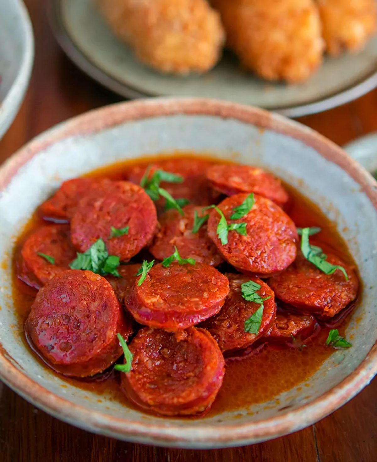 Juciy Spanish Chorizo in Red Wine in a bowl.