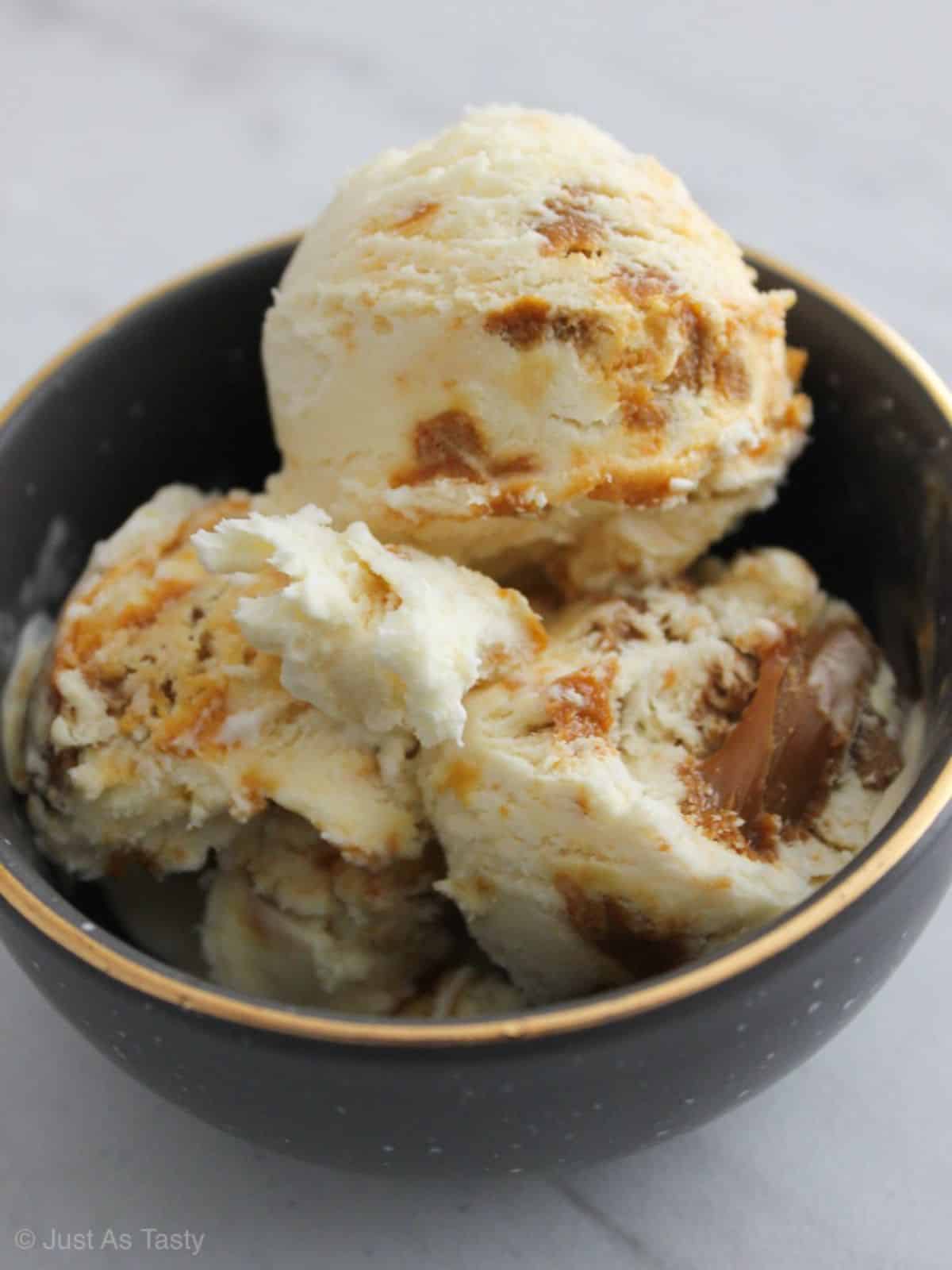 Scrumptious Caramel Ice Cream in a black bowl.