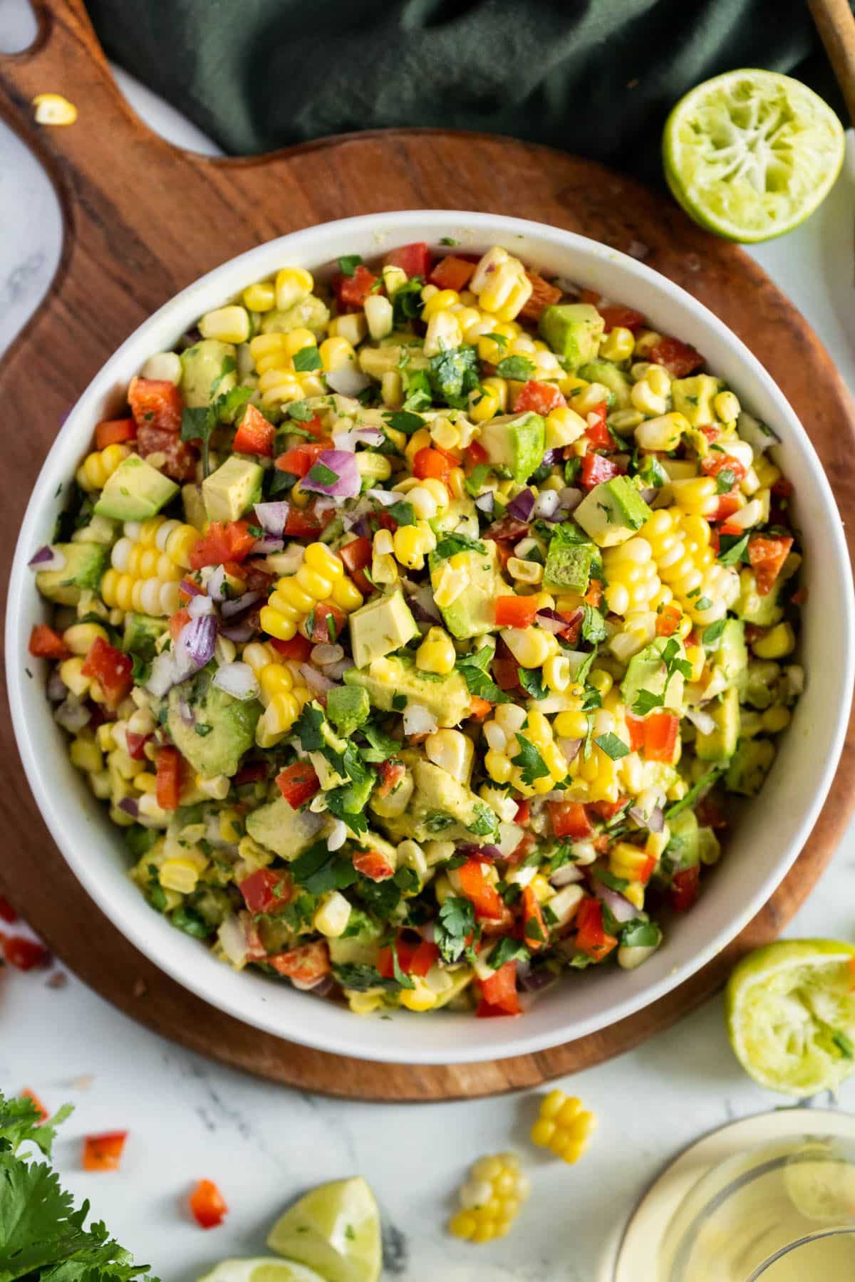 Delicious gluten-free Avocado Corn Salad in a white bowl.