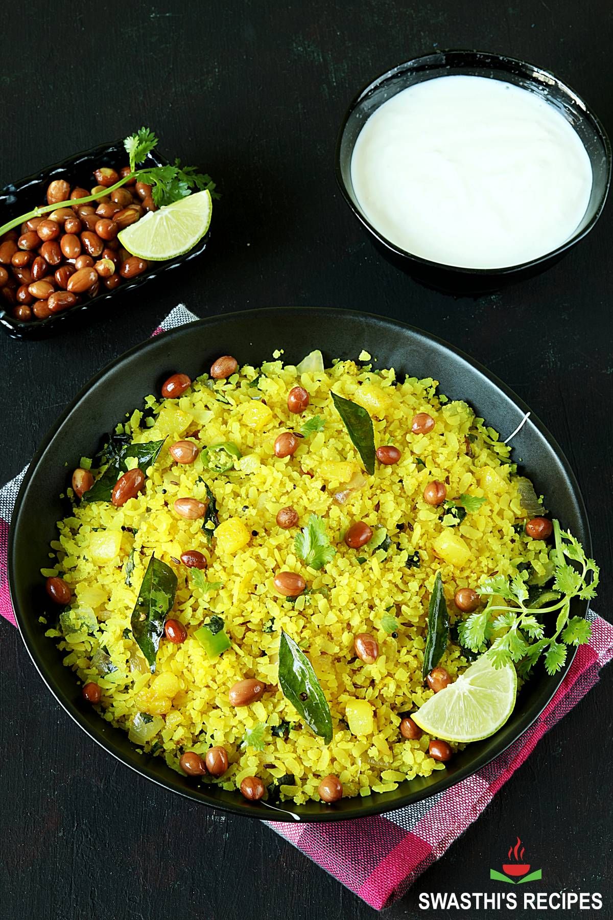 Flavorful Poha - Spiced Flattened Rice in a black bowl.