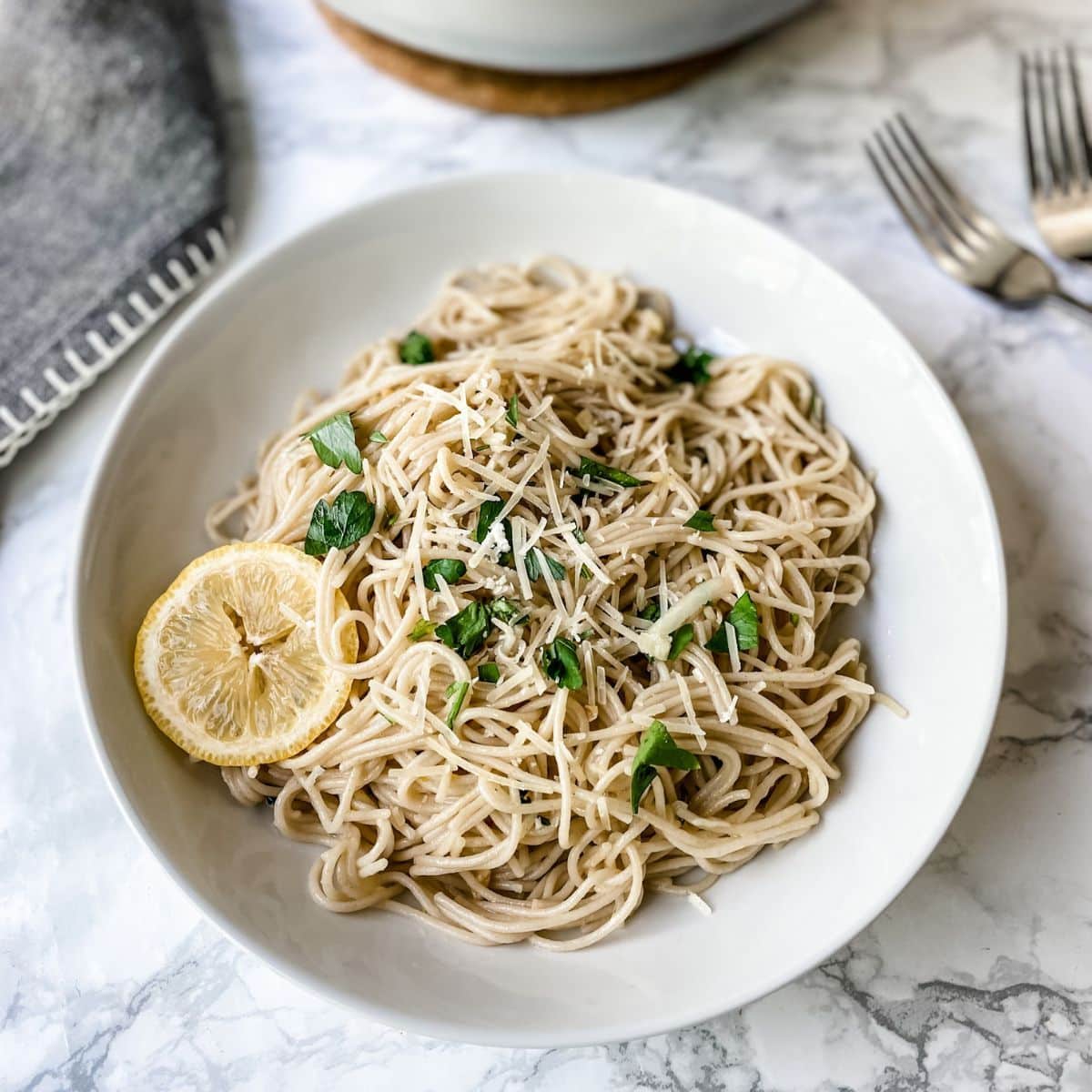 Healthy and delicious Lemon Garlic Pasta in a white bowl.