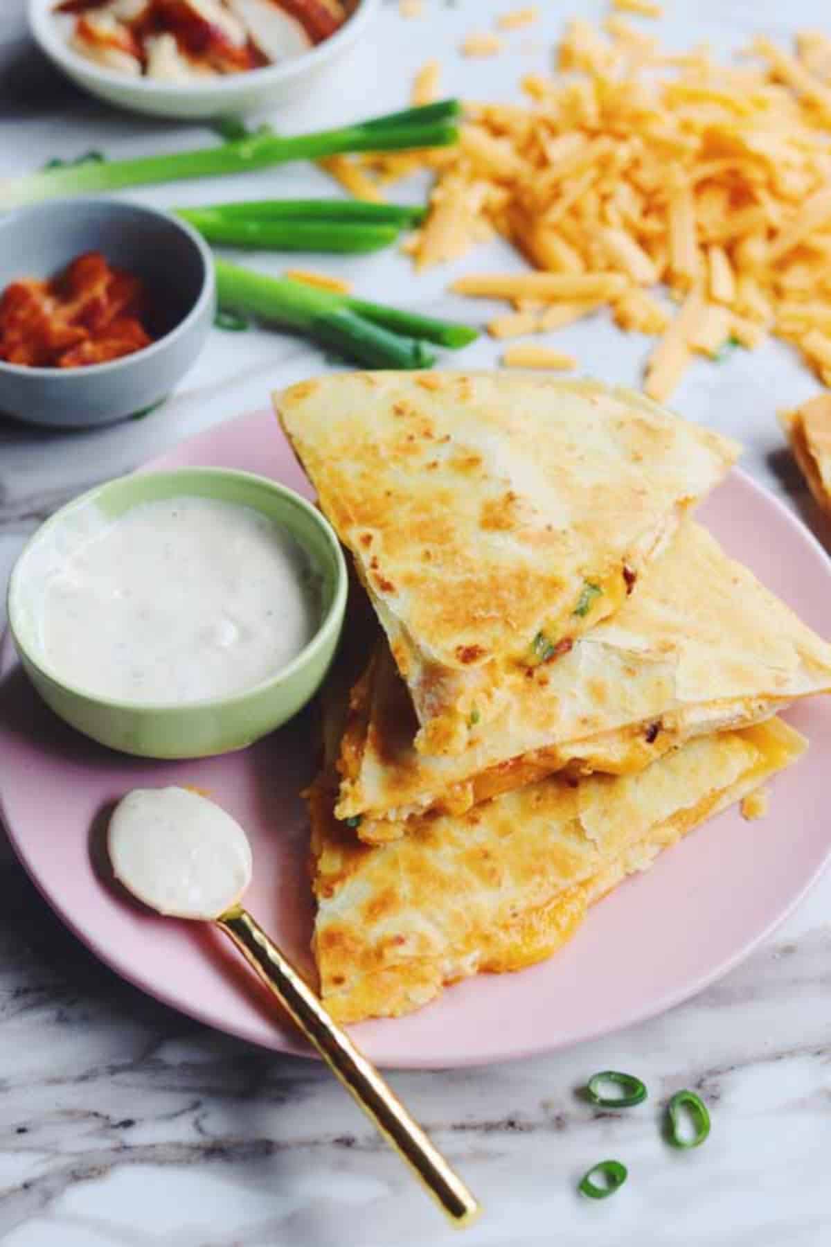 Scrumptious Cheesy Chicken Bacon Ranch Quesadillas on a pink plate.