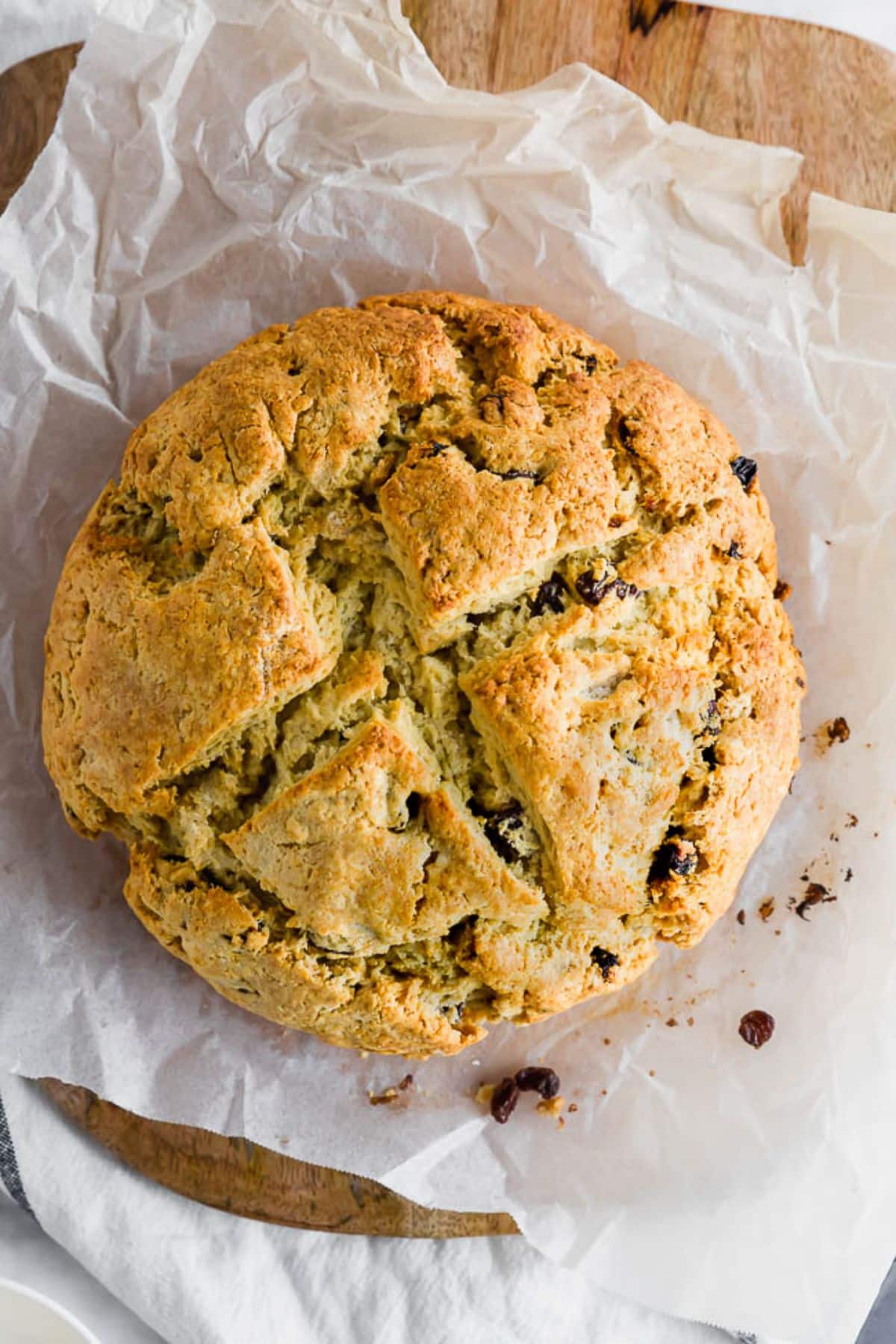 A loaf of Irish Soda Bread on a wooden tray.