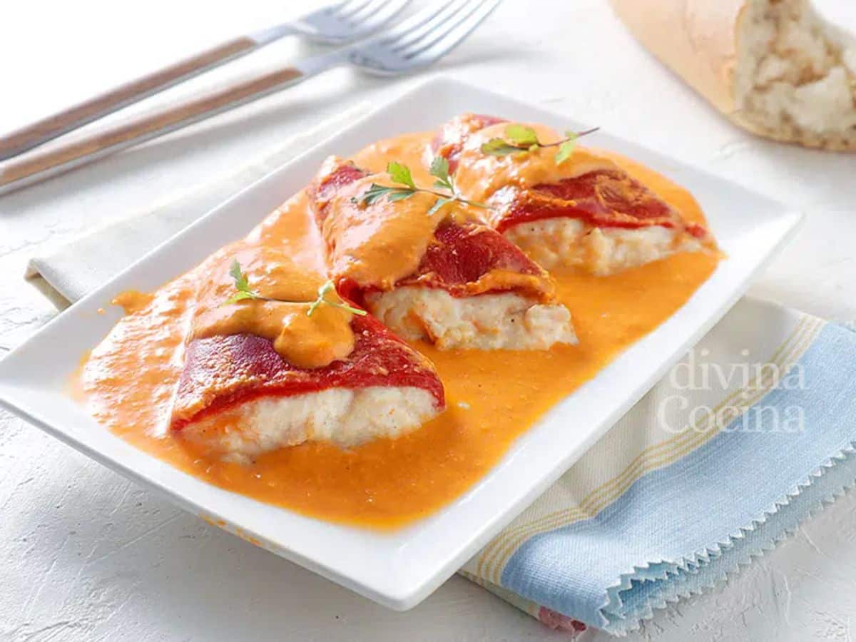 Delicious Pimientos Piquillos Relleno de Bacalao (Cod Stuffed Pimentos) on a white plate.