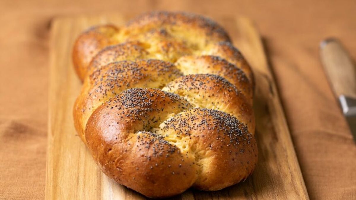 DEliicous Challah Bread on a wooden cutting board.