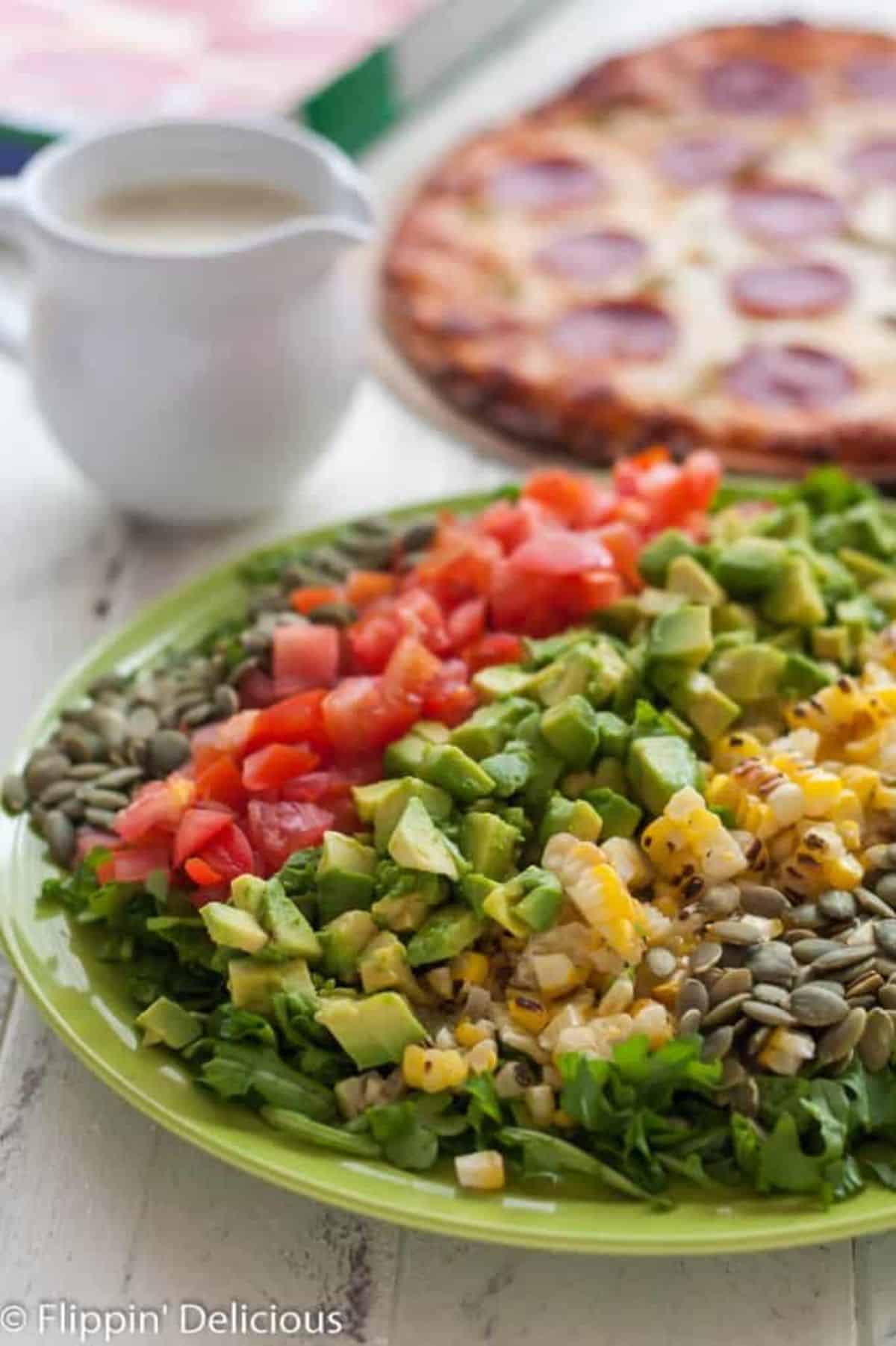 Healthy Chopped Salad with Hatch Green Chile Vinaigrette on a white plate.