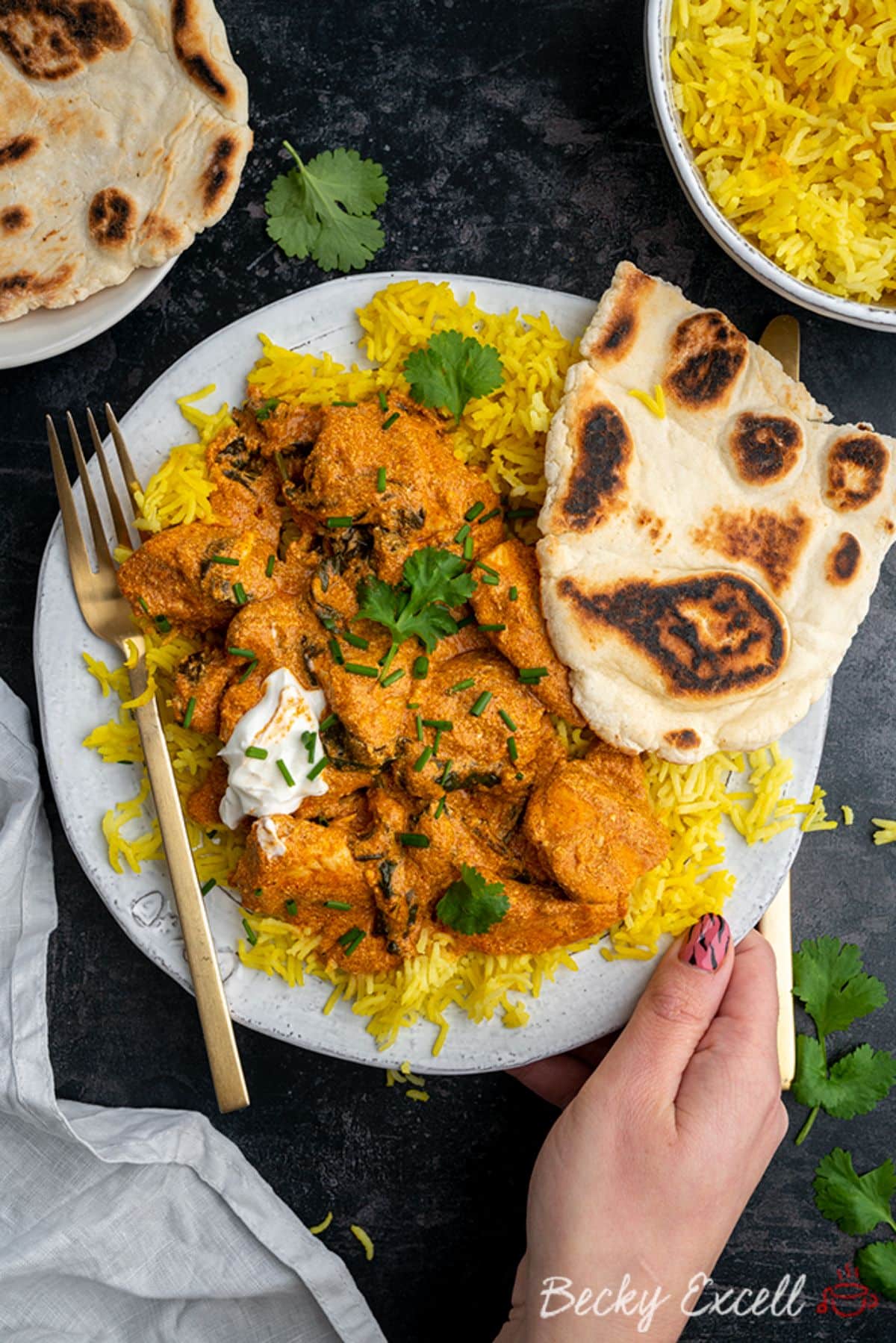 Crispy Gluten-Free Coconut Chicken Curry on a white plate with a fork.