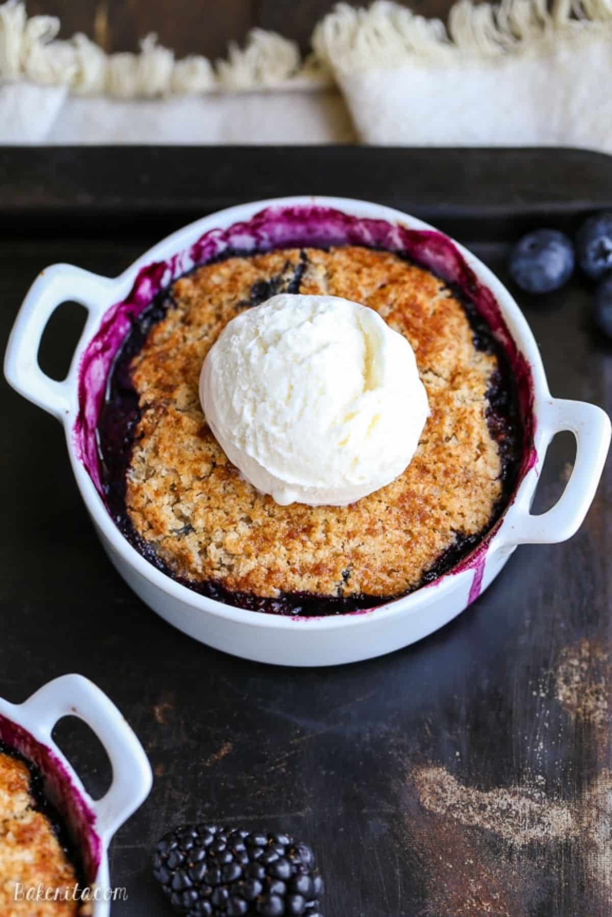 Delicious Blackberry Blueberry Cobbler in a white pot.