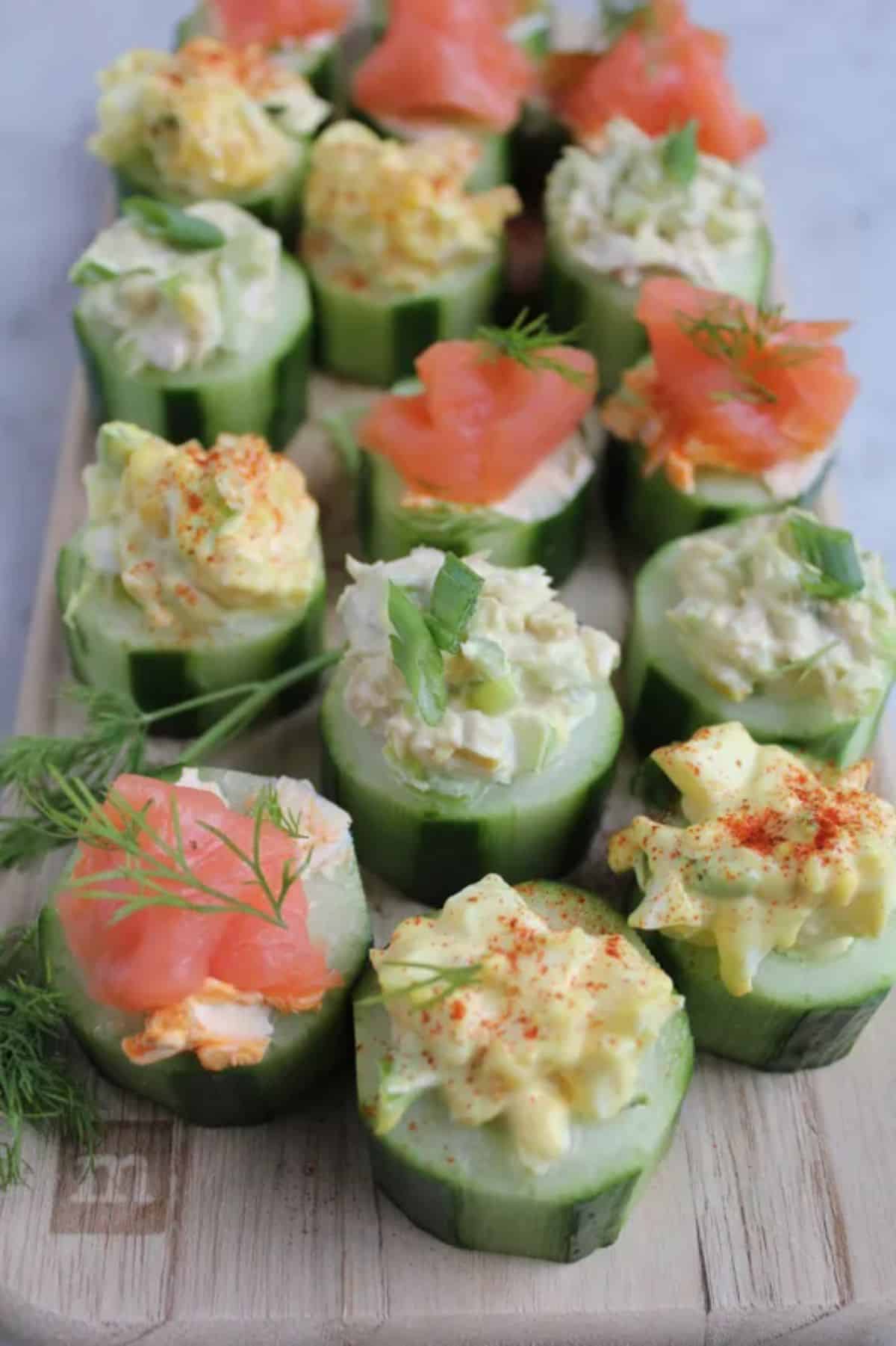 Healthy Cucumber Bites on a wooden cutting board.
