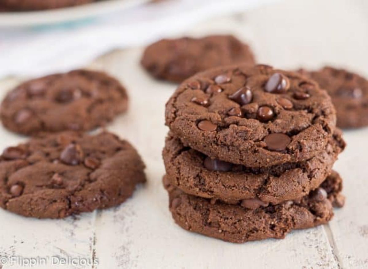 Scrumptious Double Chocolate Chip Cookies on a wooden table.