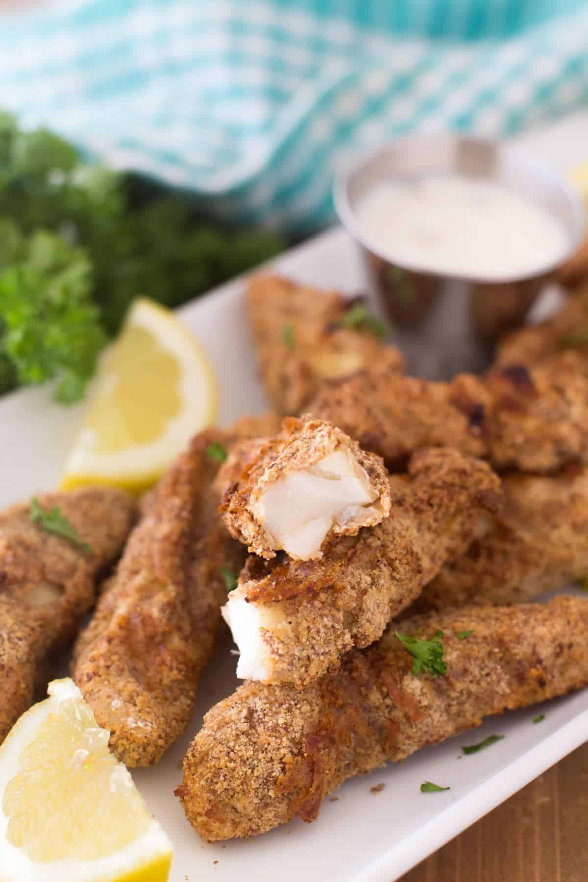 Crispy Gluten-Free Air Fryer Fish Sticks on a pink tray.