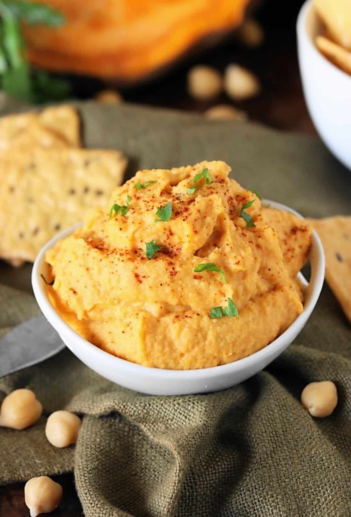 Creamy gluten-free Sweet Potato Hummus in a white bowl.