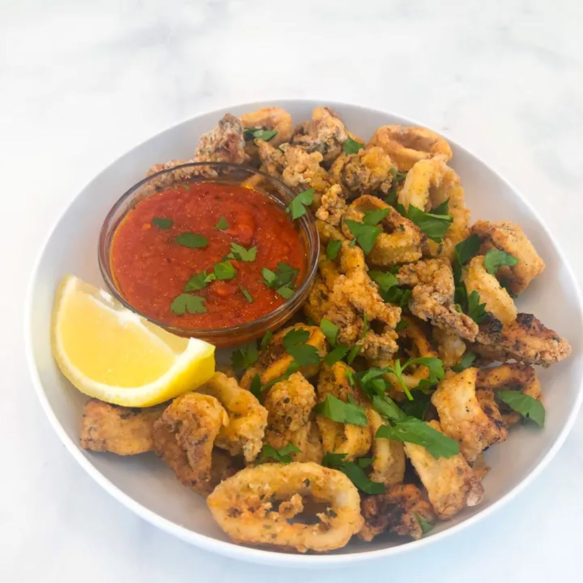 Delicious Gluten-Free Fried Calamari in a white bowl.