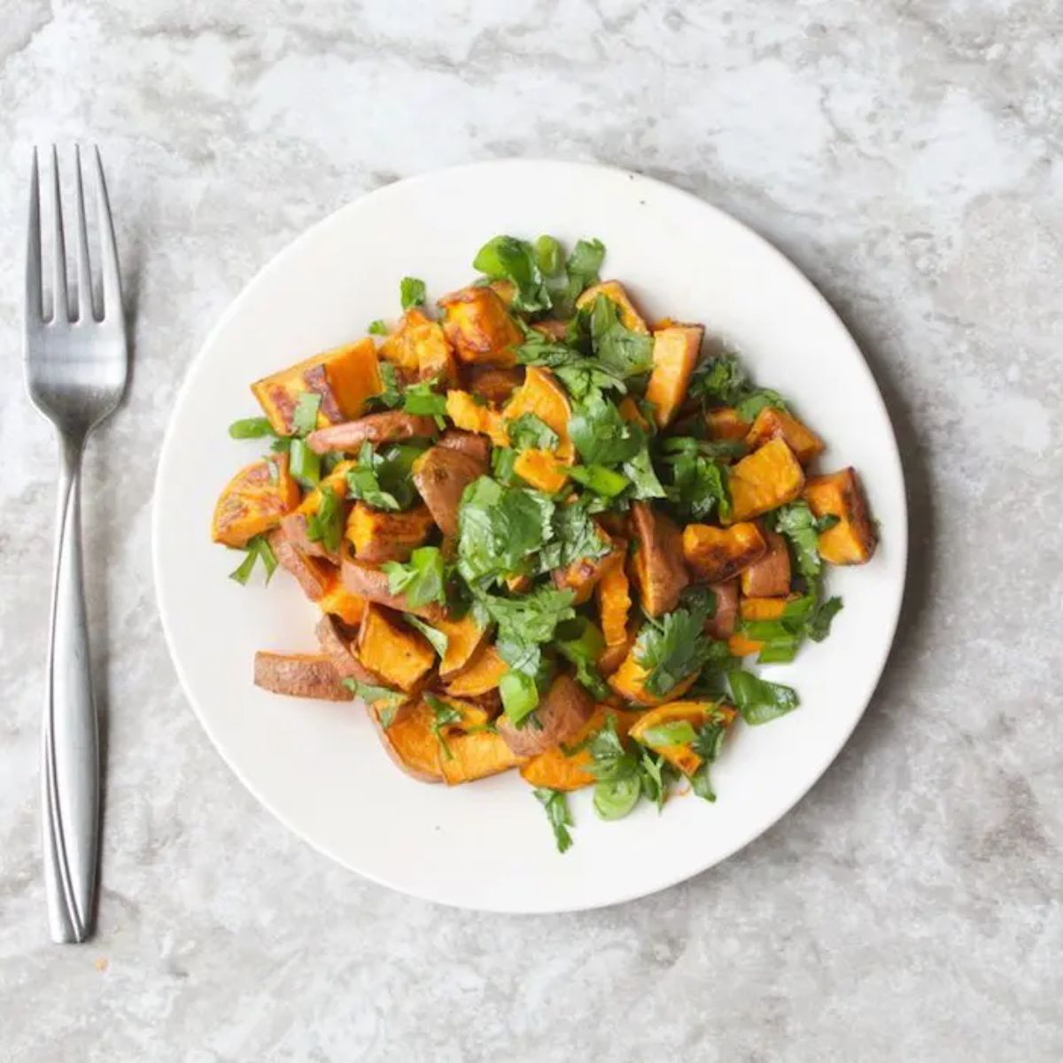 Healthy Roasted Sweet Potato Salad with Honey Lime Vinaigrette on a white plate.