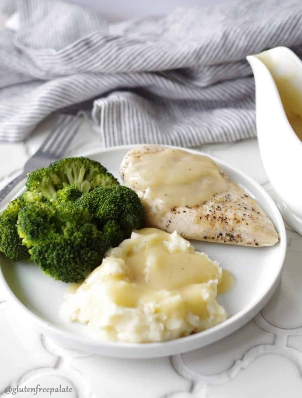 Five-Minute Gluten-Free Gravy on a piece of chicken, mashed potatoes and broccoli on a white plate.