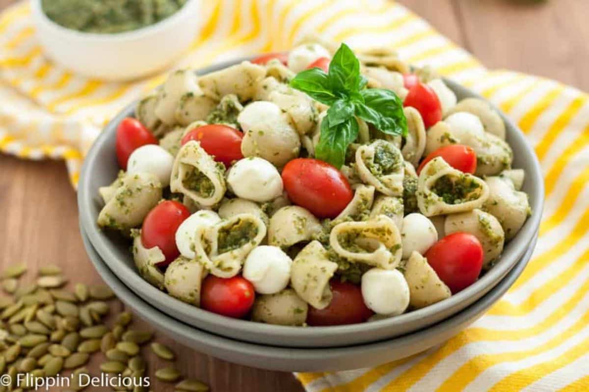 Healthy Gluten-Free Pasta Salad with Pumpkin Seed Pesto in a gray bowl.