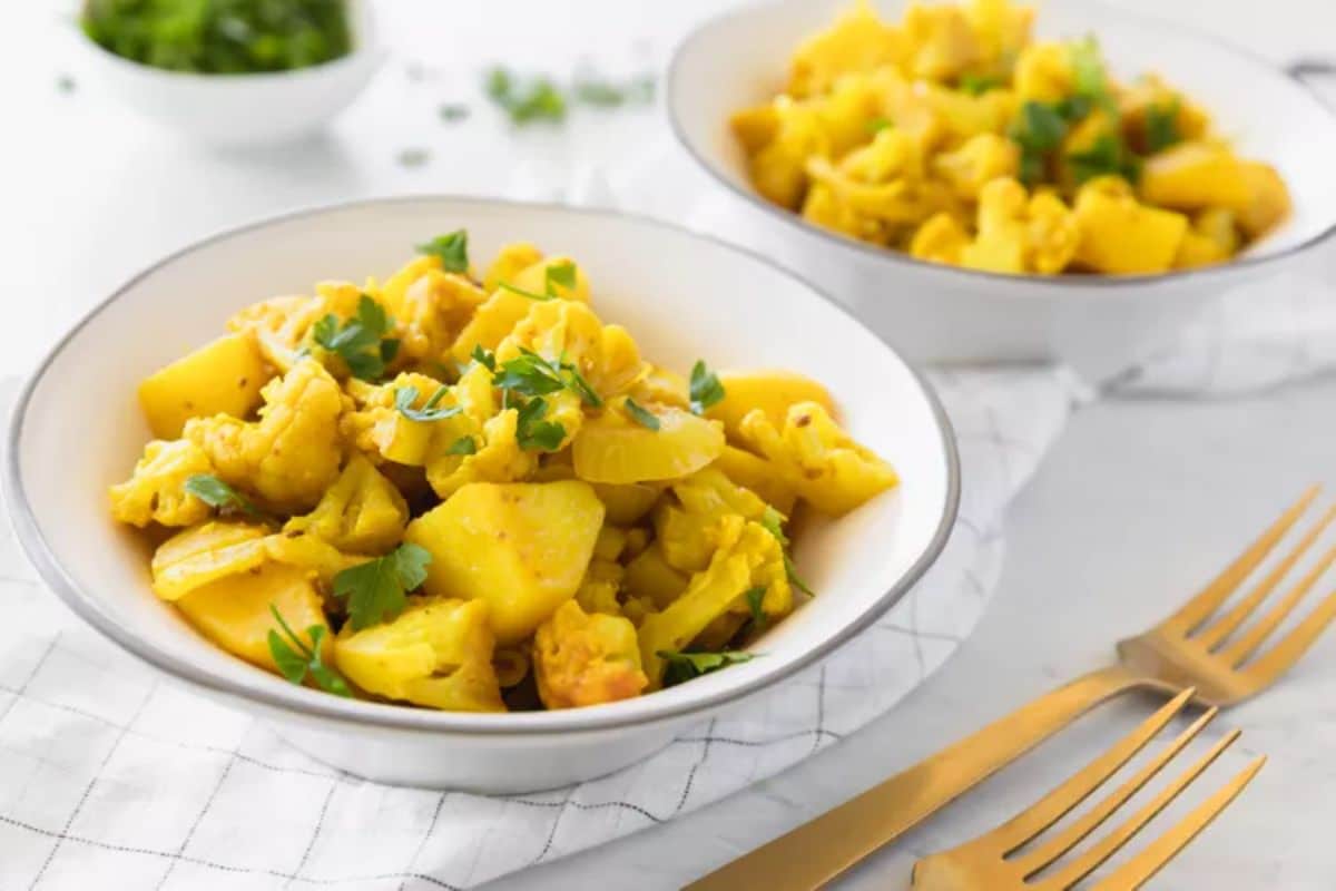 Healthy Indian Aloo Gobi in two white bowls.