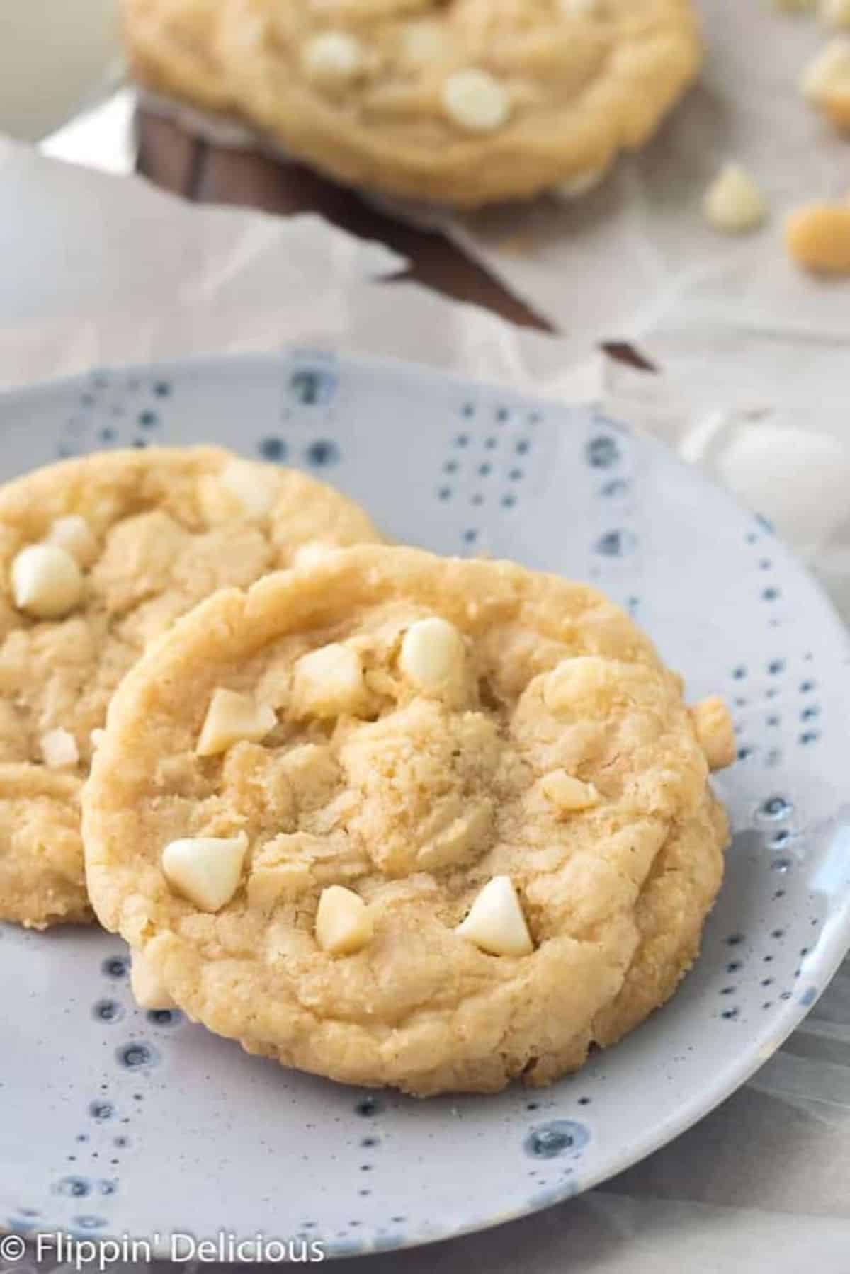 Crunchy Gluten-Free White Chocolate Macadamia Nut Cookies on a small blue plate.