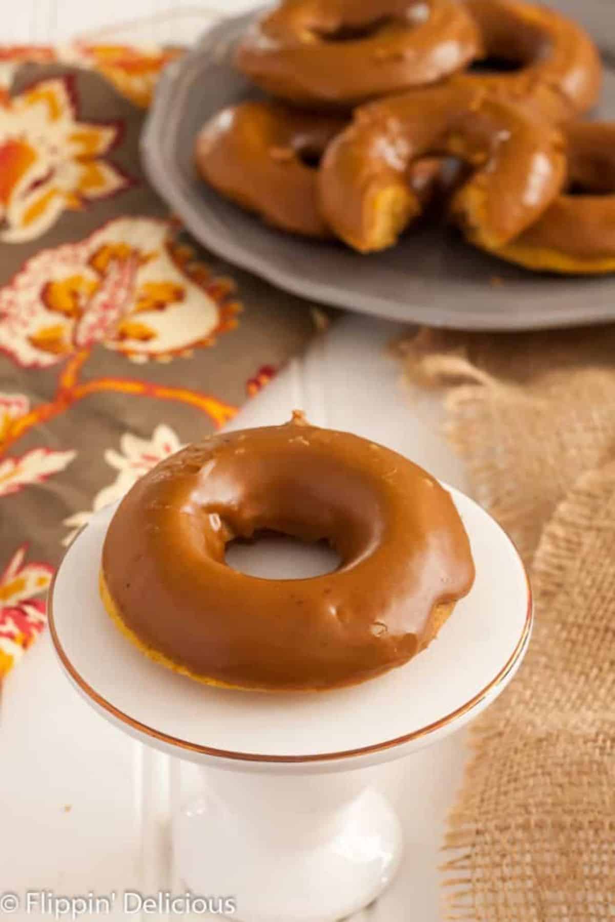 Sweet Gluten-Free Pumpkin Spice Latte Donut on a cake tray.