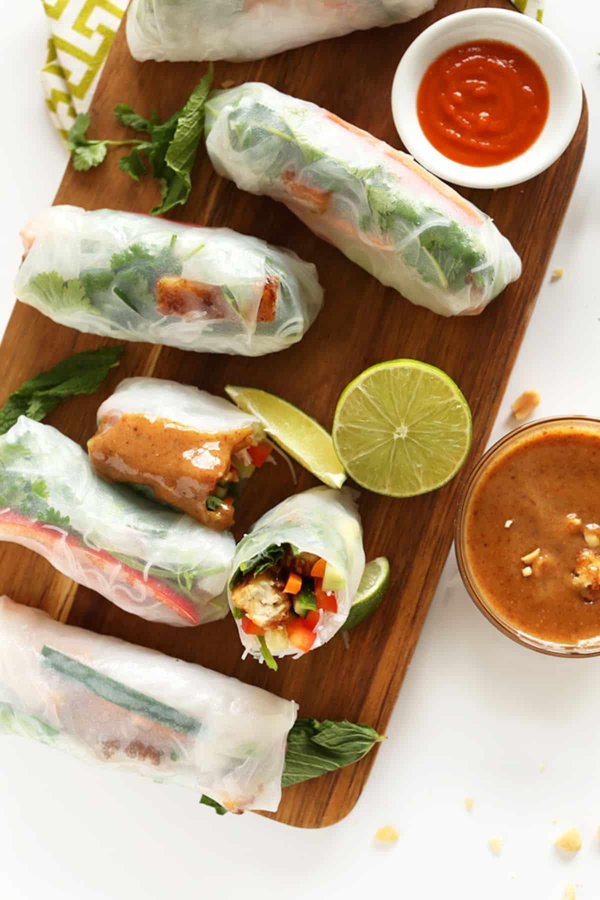 Scrumptious gluten-free Vietnamese Spring Tofu Rolls on a wooden tray.