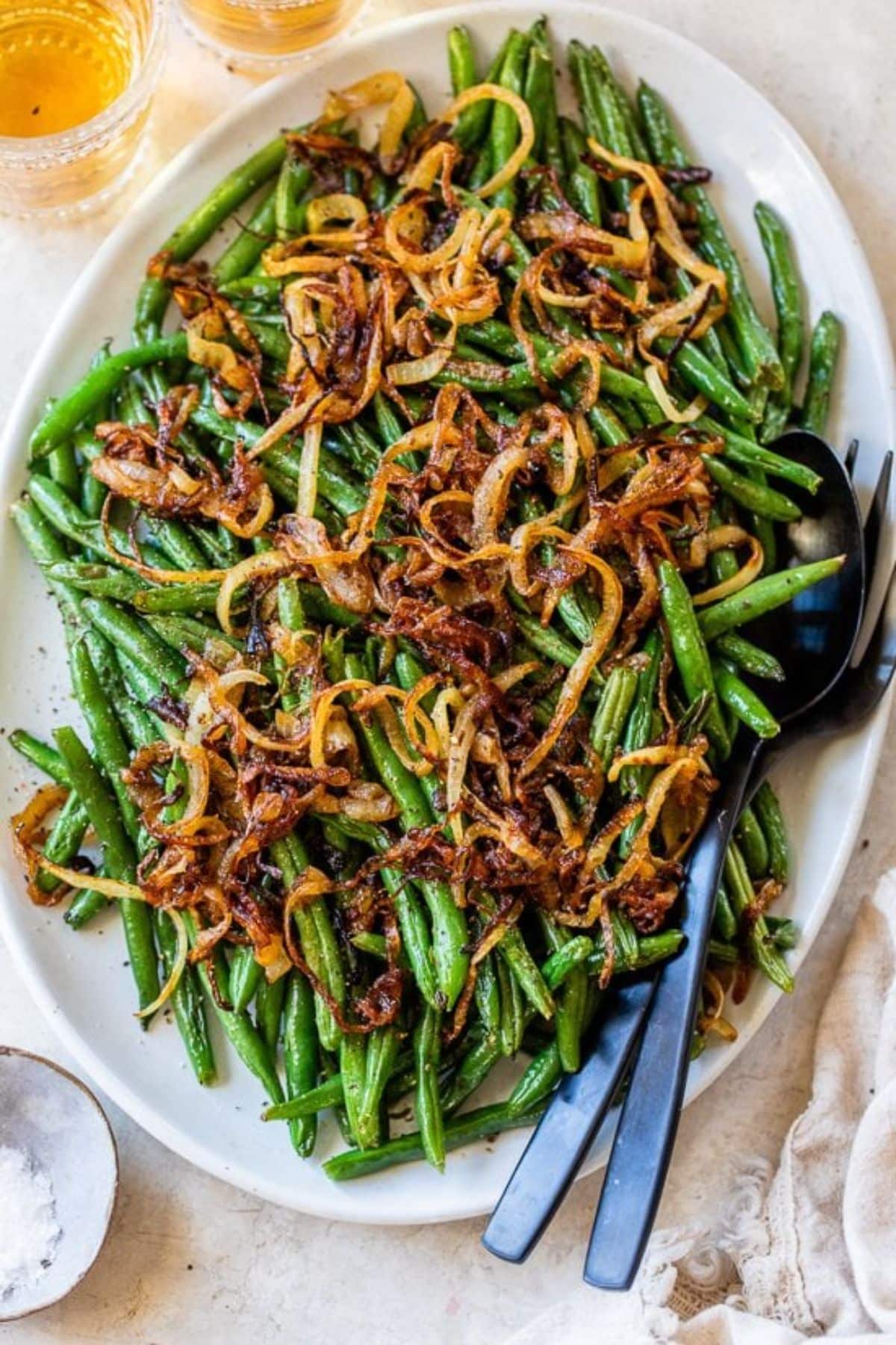 Delicious Roasted Green Beans With Caramelized Onions on a white tray.