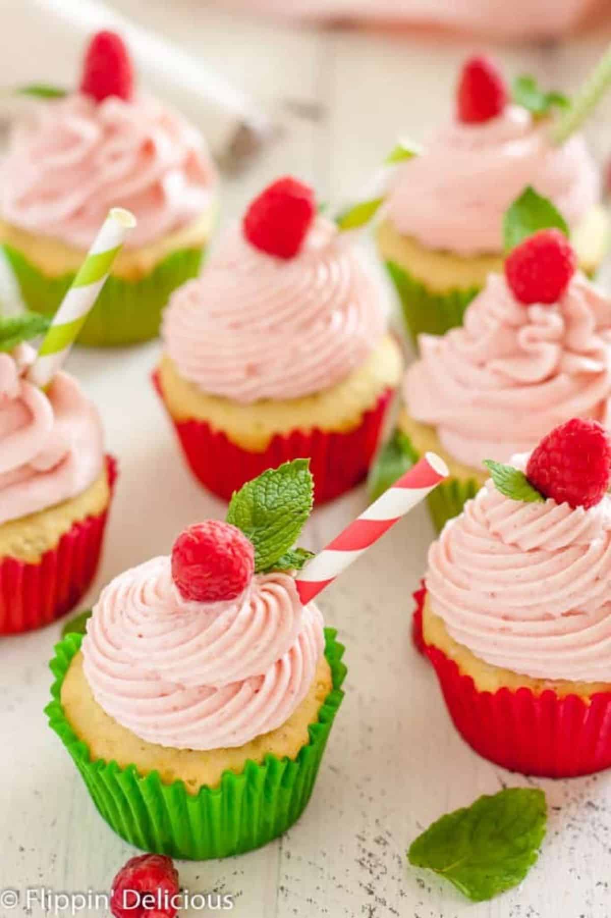 Mouth-watering Gluten-Free Raspberry Lime Mojito Cupcakes on a table.