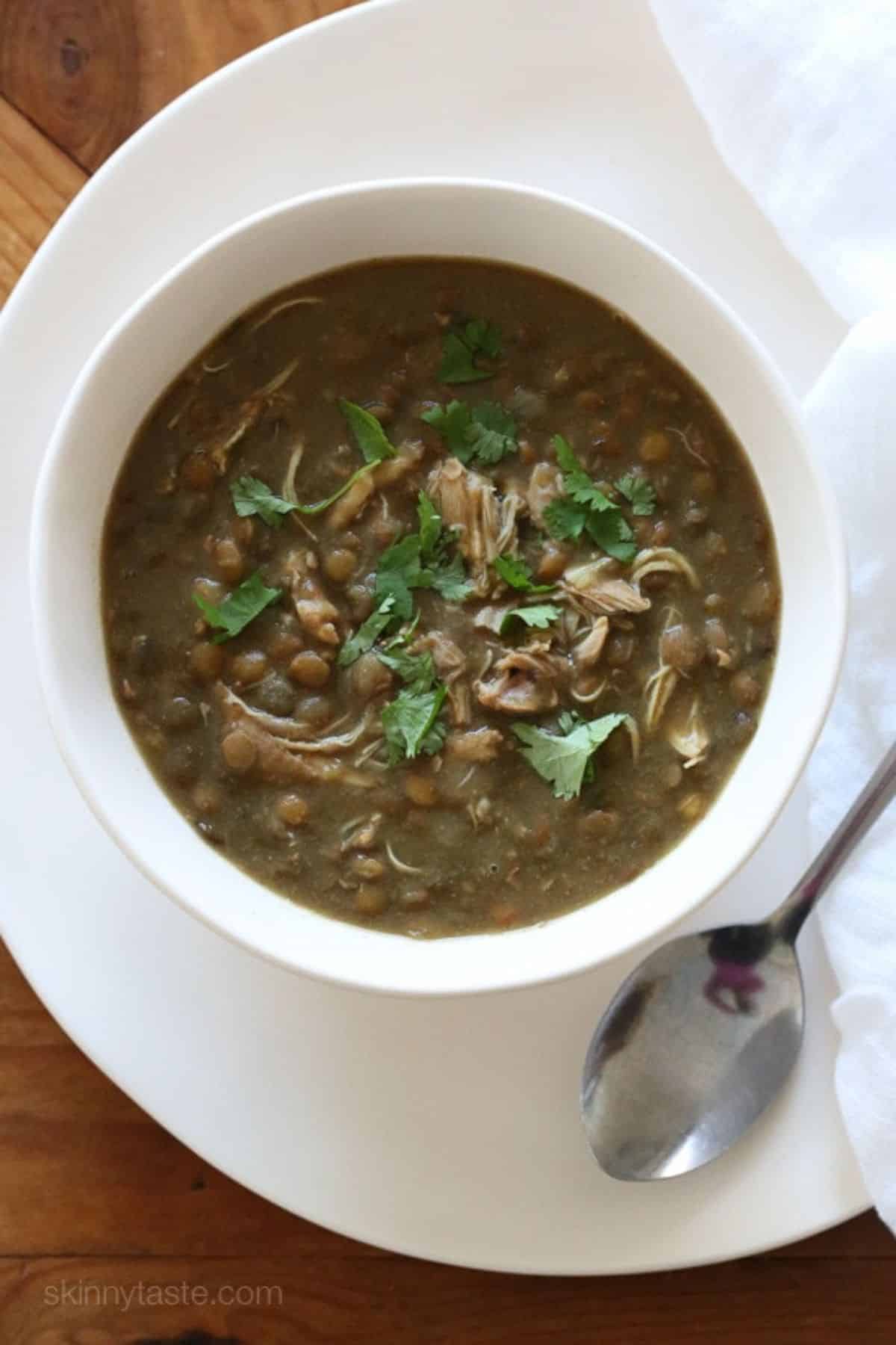 Flavorful Chicken and Lentil Soup in a white bowl.