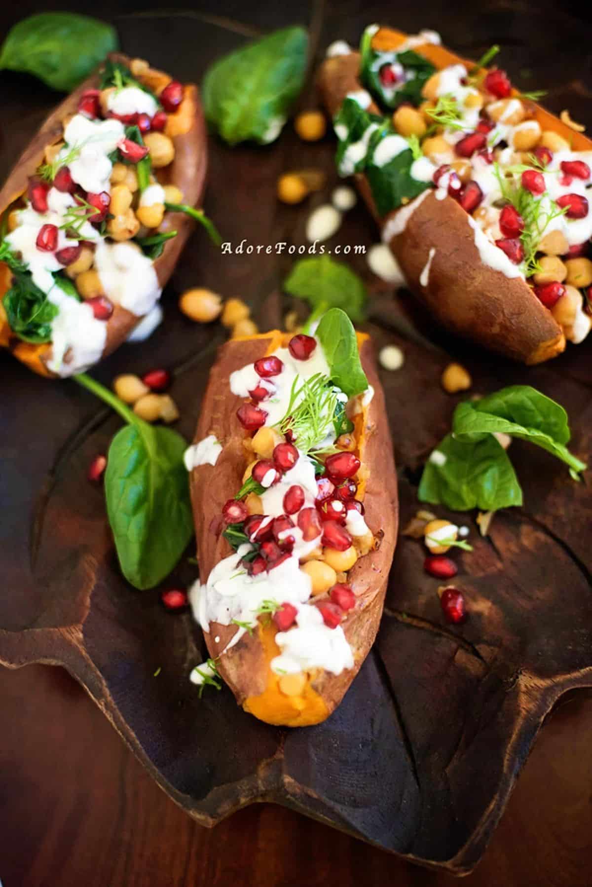 Scrumptious Stuffed Sweet Potatoes with Chickpeas on a wooden tray.