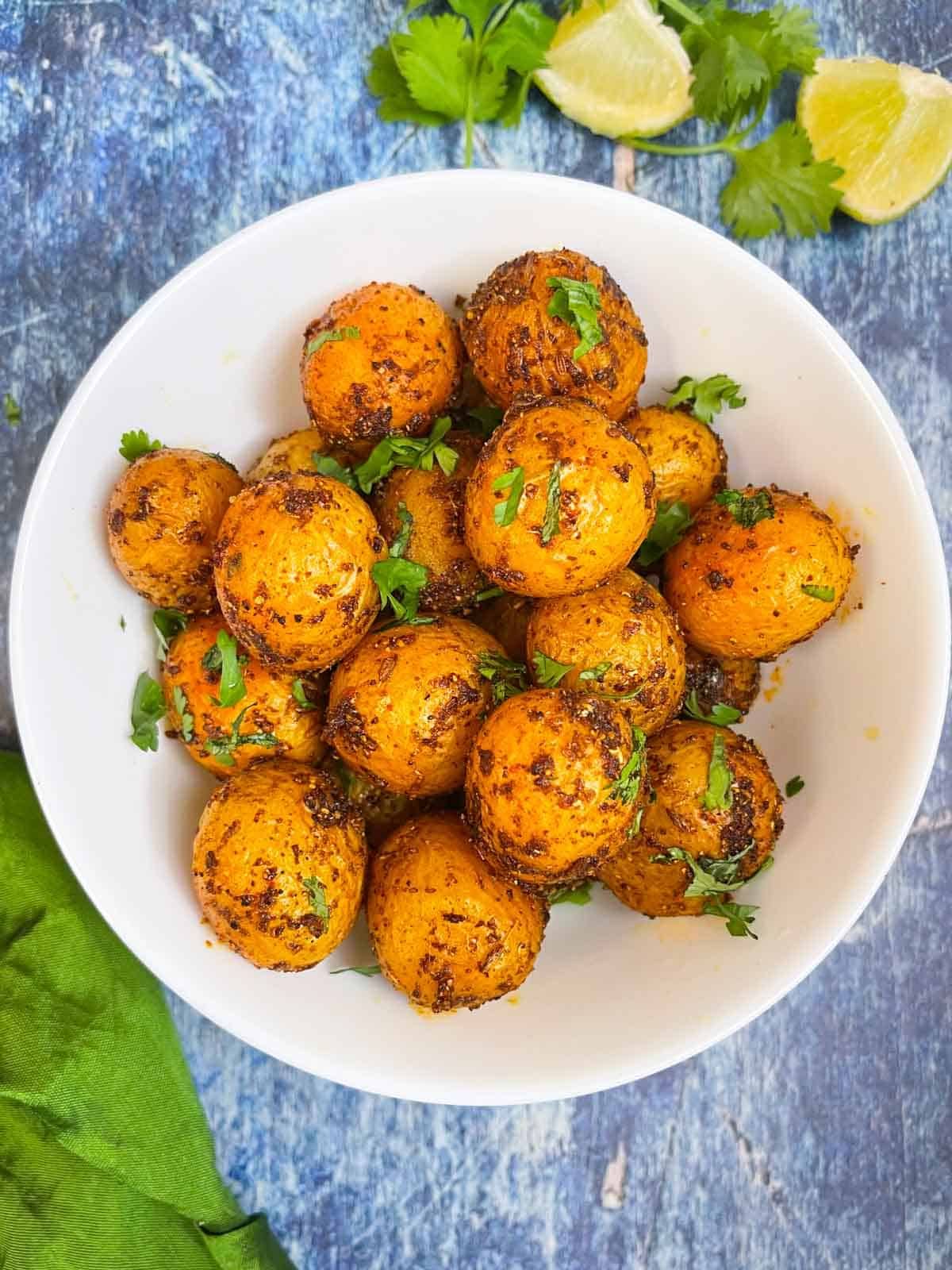 Delicious Spicy Bombay Potatoes in a white bowl.