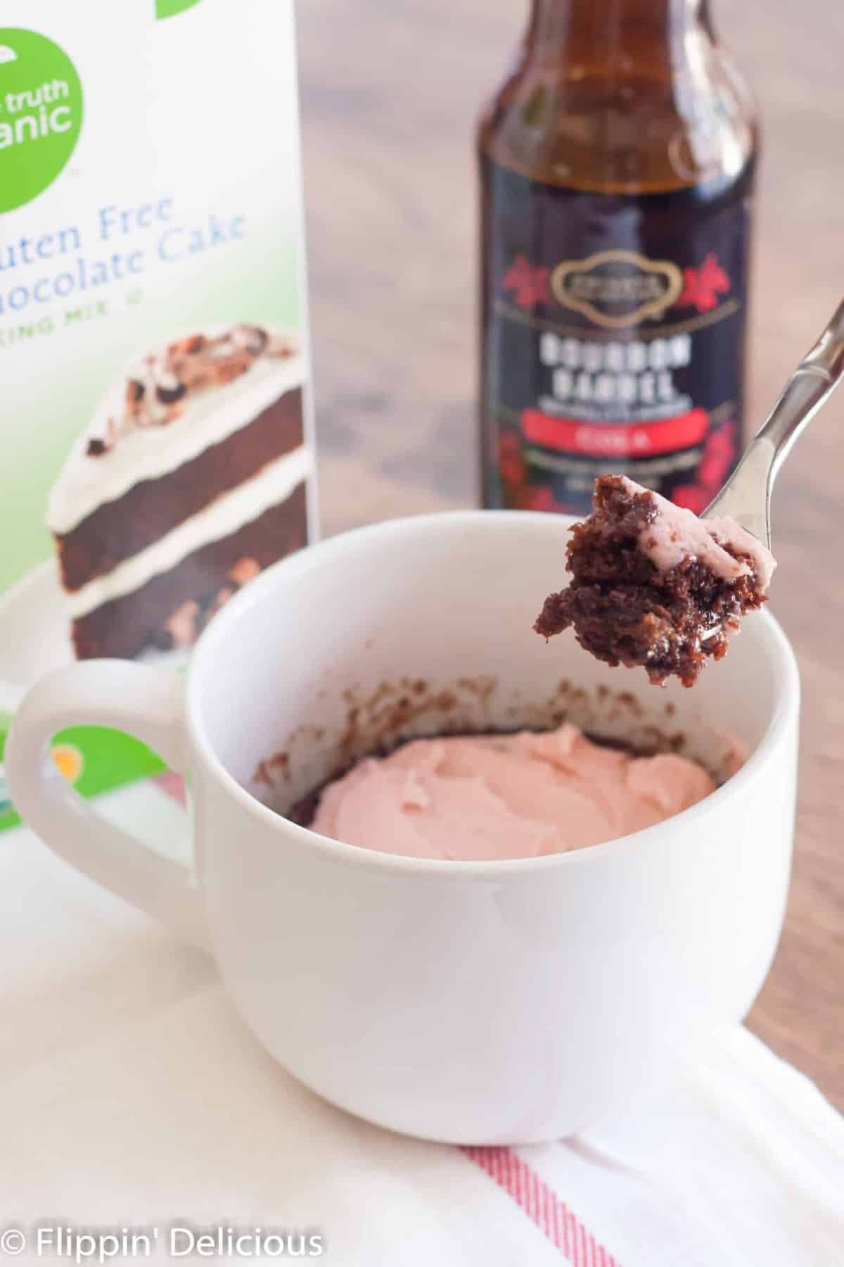 Tasty Chocolate Mug Cake on a table and scooped on a fork.