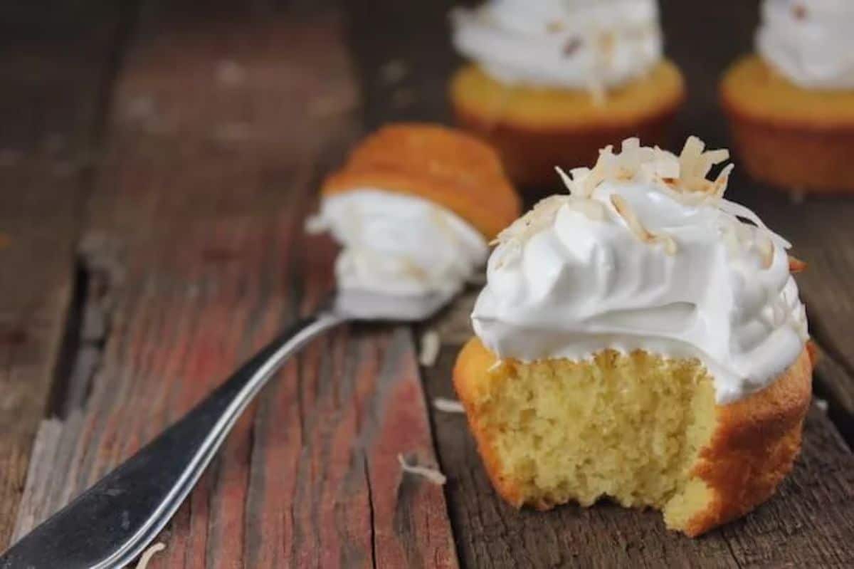 Tasty Coconut Flour Cupcakes on a wooden table with a fork.