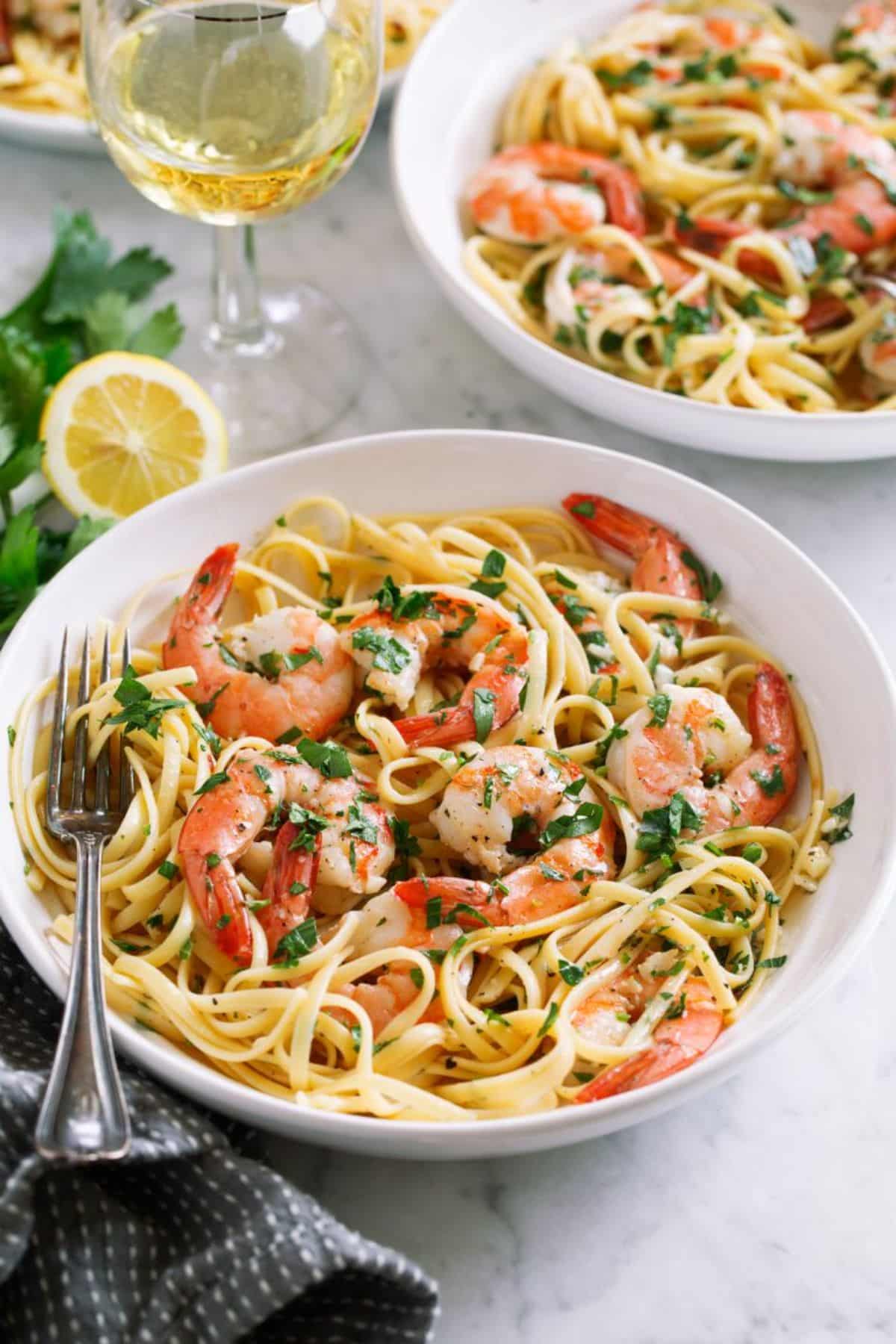 Healthy and delicious Shrimp Scampi in a white bowl with a fork.