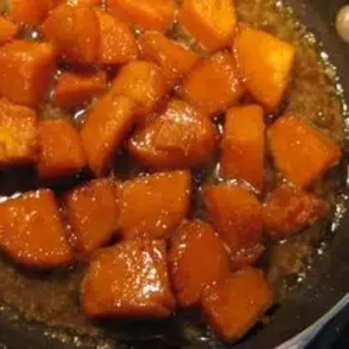 Delicious Brandied, Candied Sweet Potatoes in a skillet.