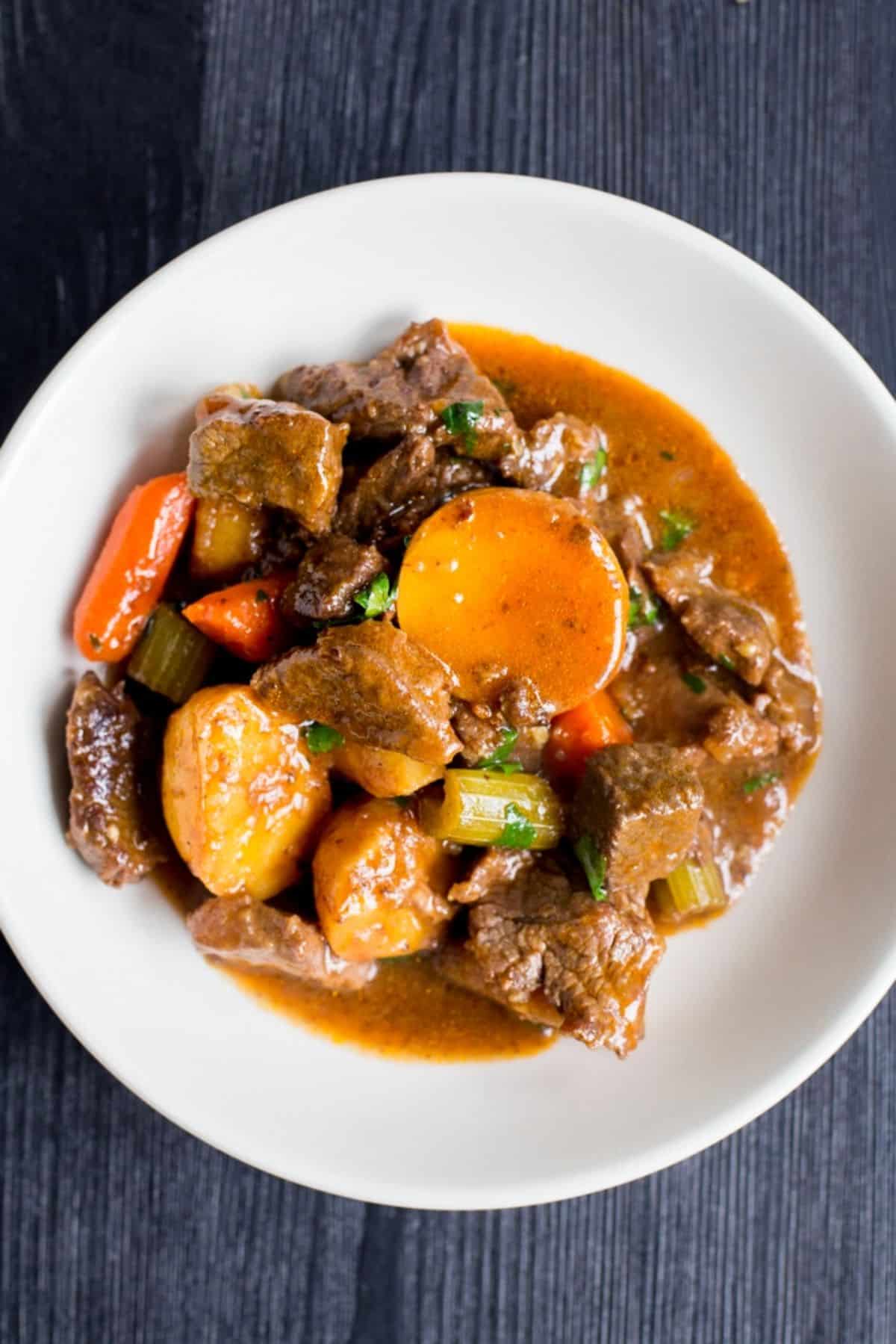 Tasty Instant Red Wine Beef Stew on a white plate.