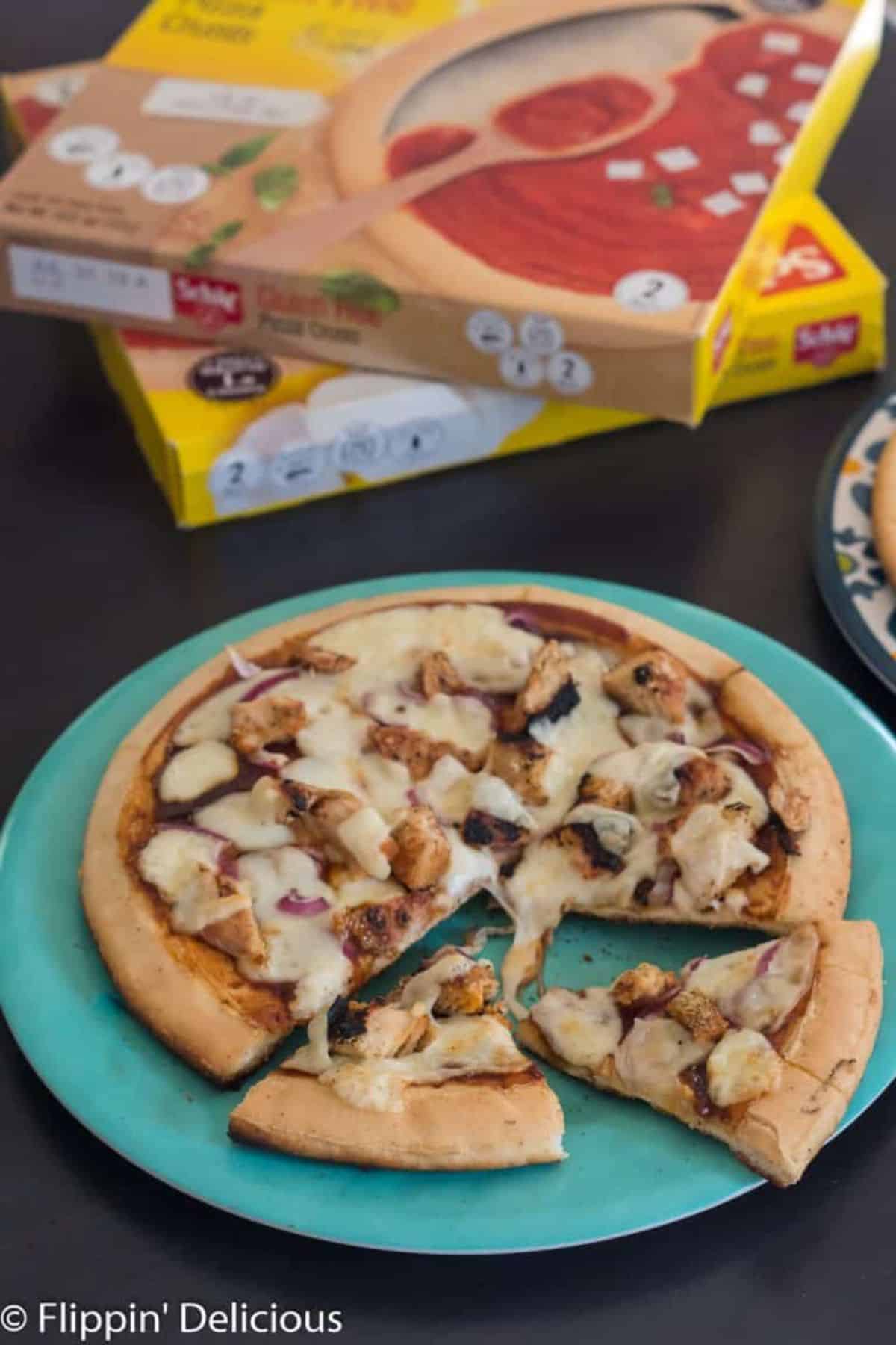 Delicious Gluten-Free Grilled Pizza (Spinach Artichoke and Barbecue Chicken) on a blue plate.