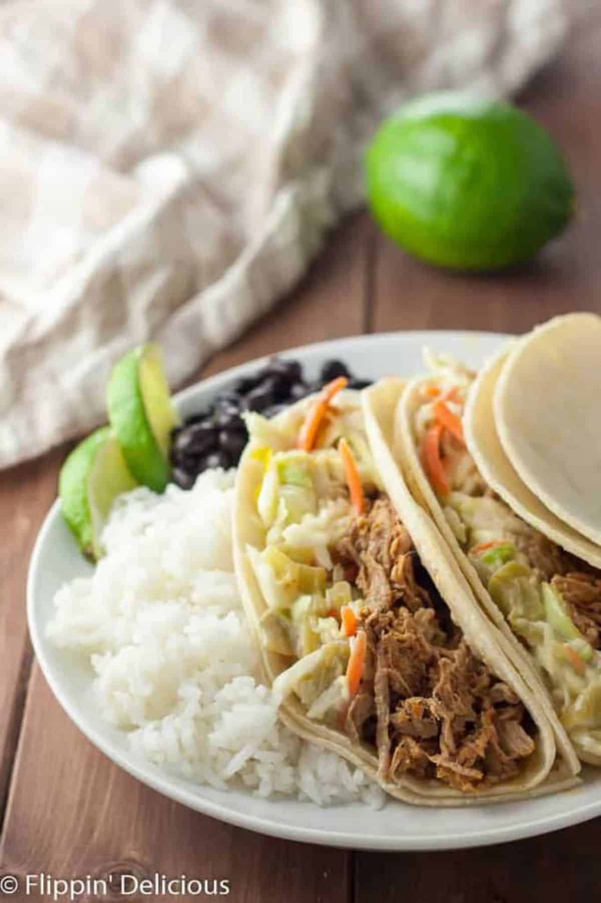 Healthy Gluten-Free Pulled Pork With Green Chile Slaw with rice on a white plate.