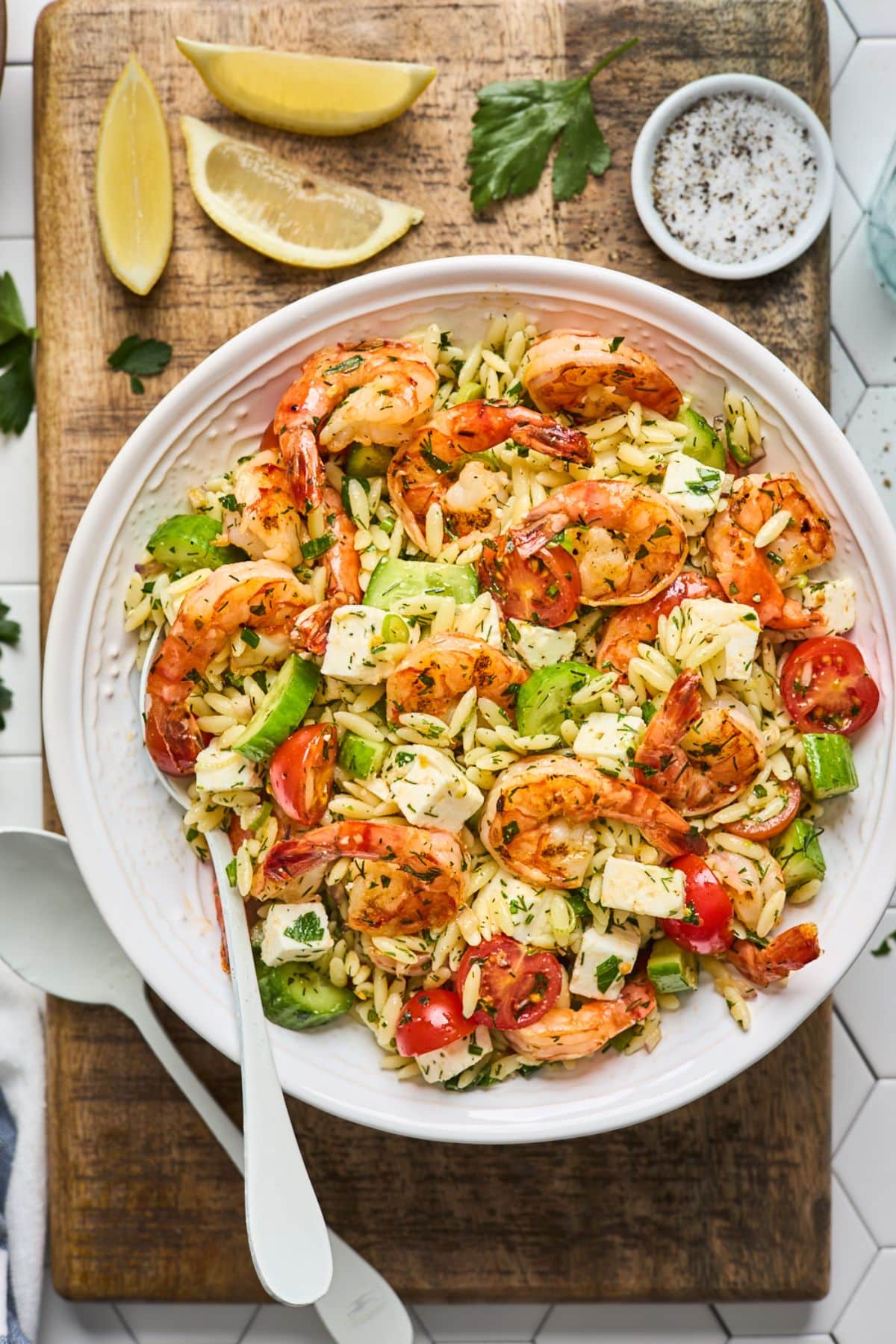 Healthy Greek Style Grilled Shrimp Orzo Pasta Salad on a white plate with a fork.