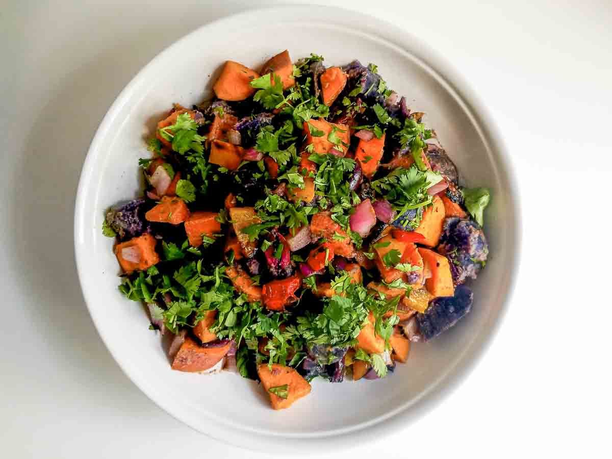 Mouth-watering gluten-free Rainbow Potato Salad in a white bowl.