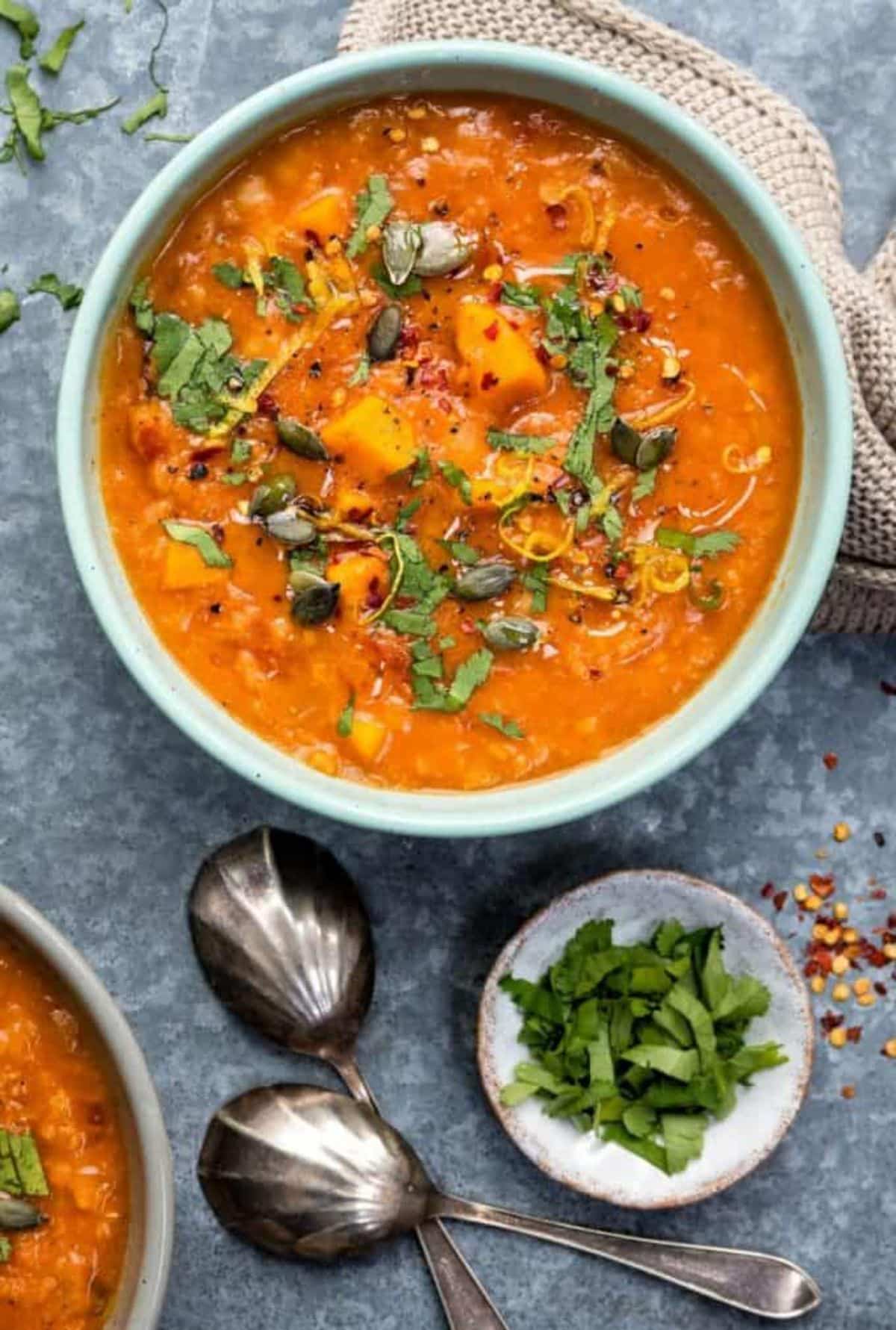 Creamy Sweet Potato, Chickpea, and Red Lentil Soup in a blue bowl.