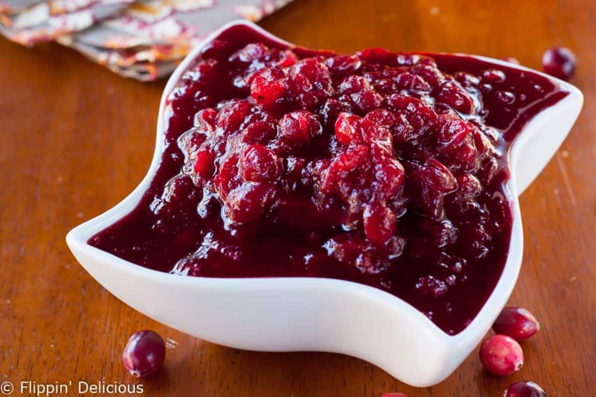 Delicious 15 Minute Cranberry Sauce with Cider and Orange in a white bowl.