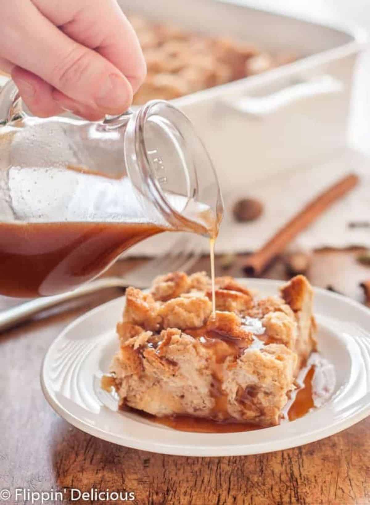 A piece of Gluten-Free Chai French Toast on a white plate drizzled with syrup.