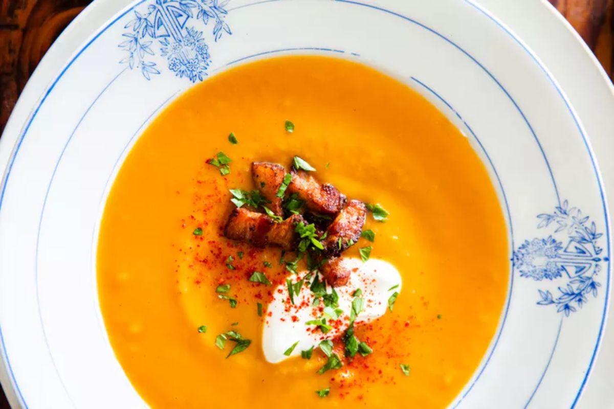 Delicious Butternut Squash Soup with Bacon and Crème Fraîche on a plate.