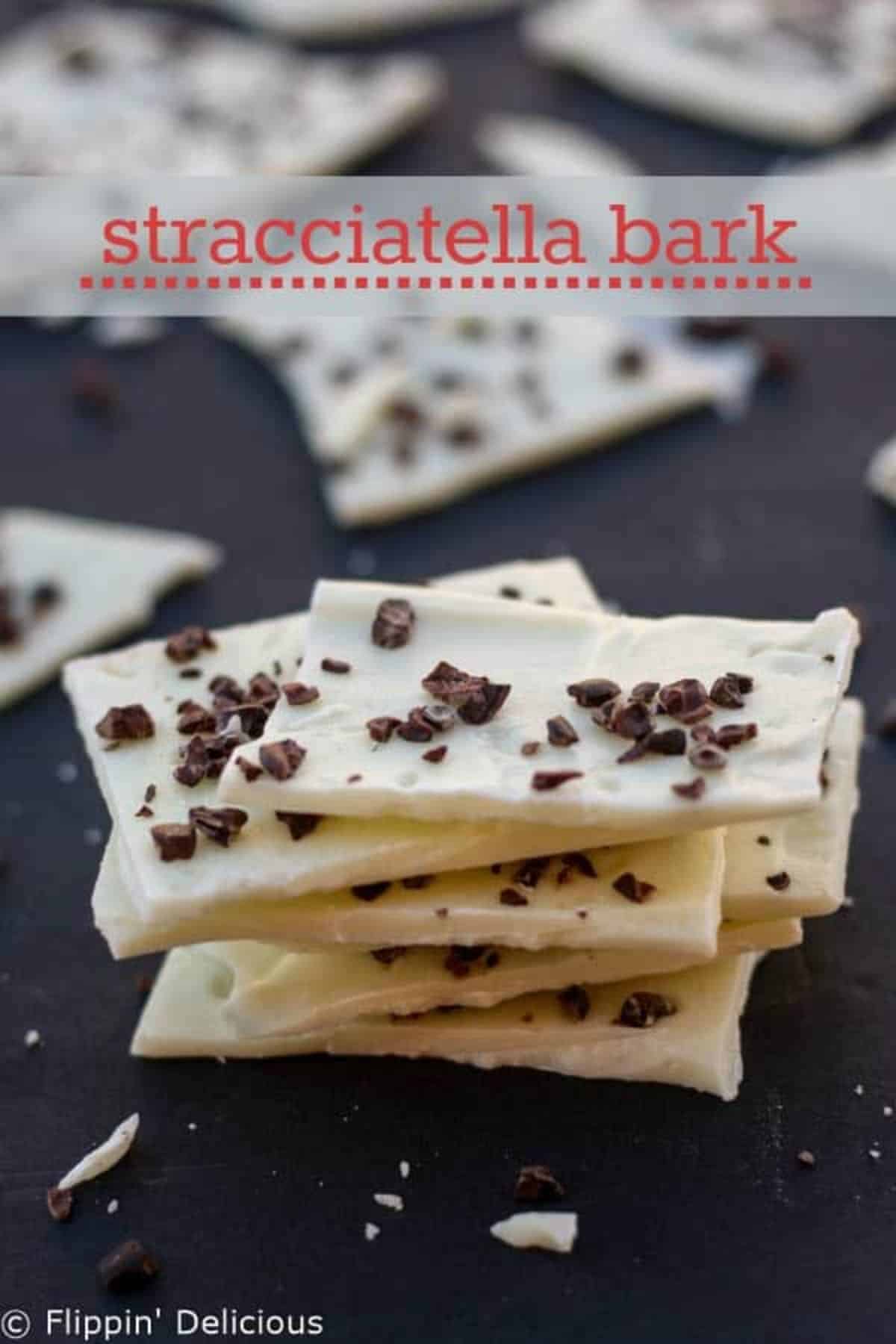 A pile of White Chocolate Bark on a black tray.