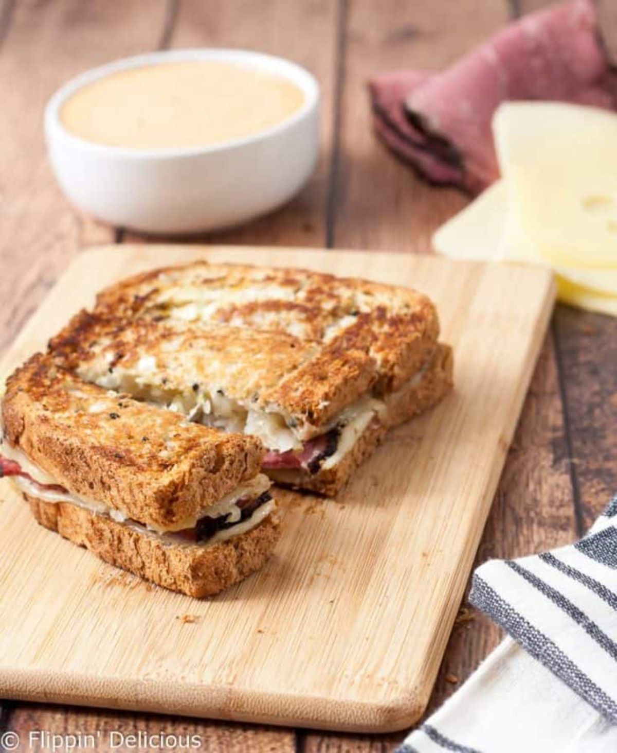 Delicious Gluten-Free Reuben Sandwich Dipper on a wooden cutting board.